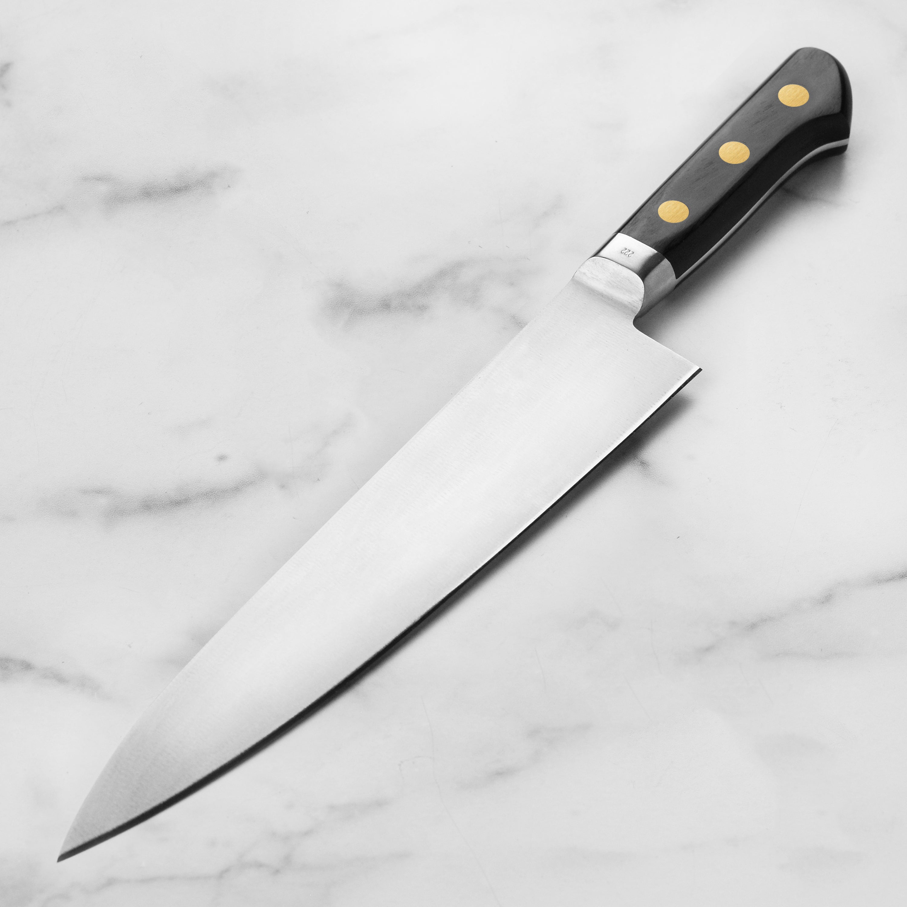 Close-up of the hand-forged carbon steel blade with a sharp edge