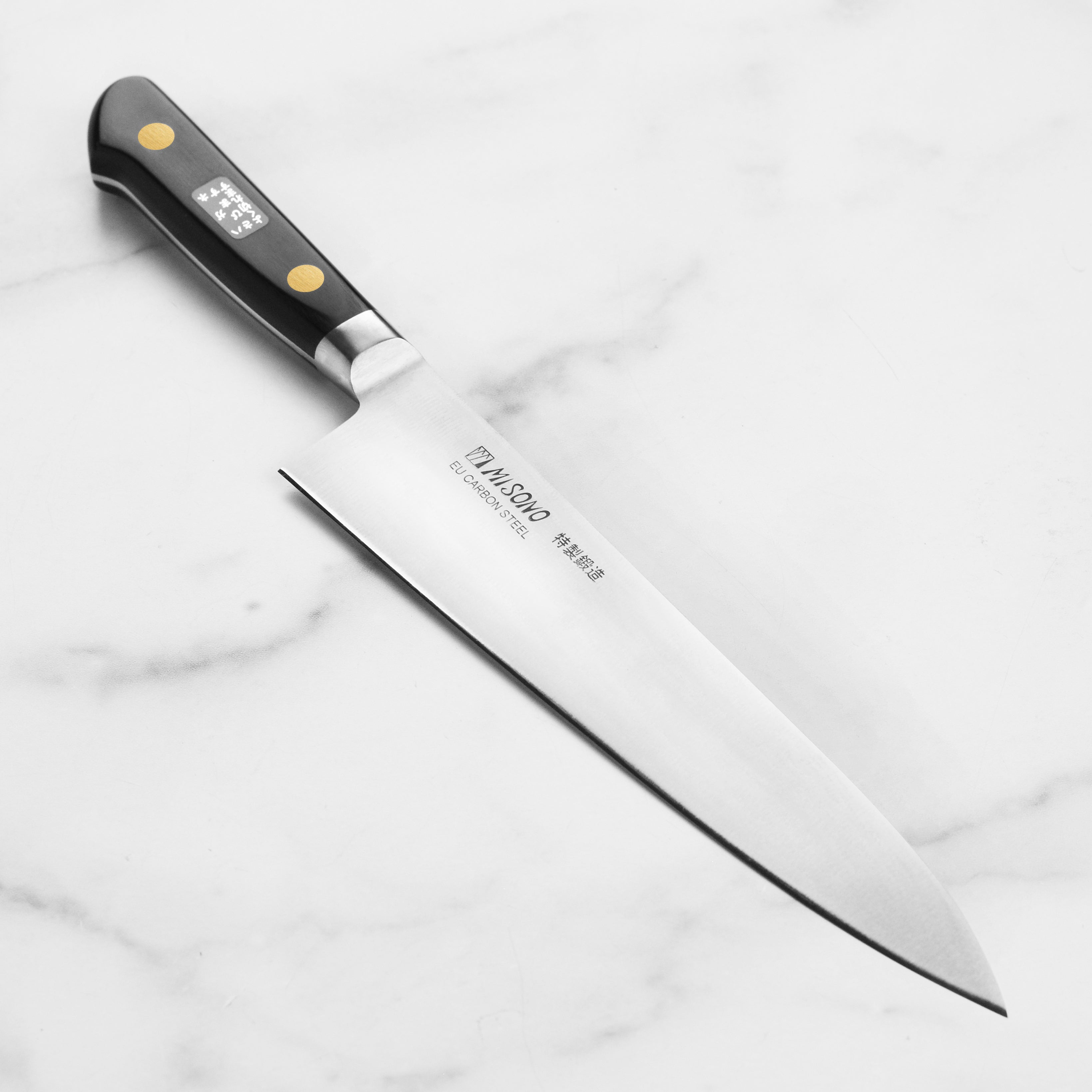 Misono Swedish Carbon Steel Gyuto Chef Knife angled view showcasing the blade and handle design.