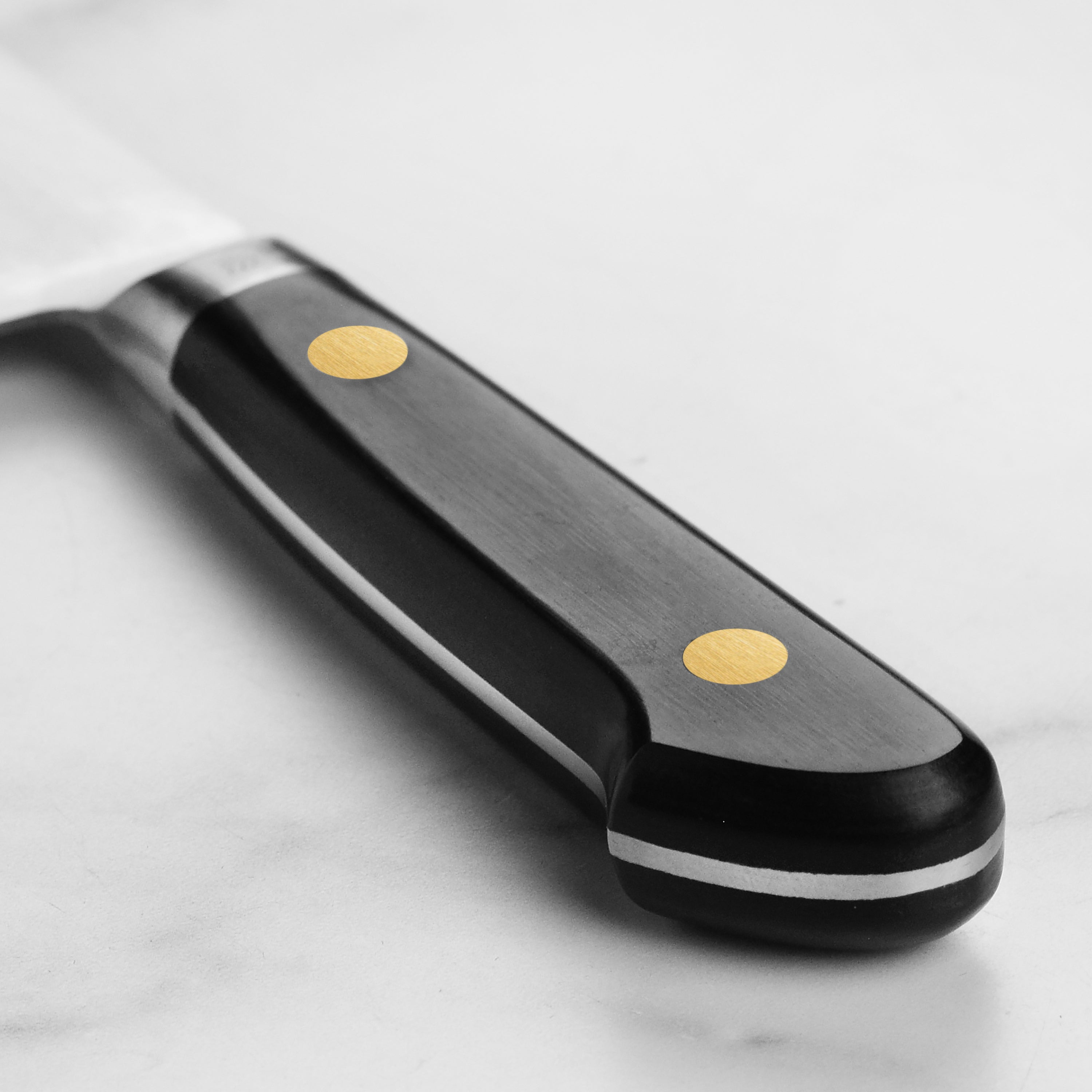 Close-up of the black Pakkawood handle with brass rivets on the Misono Gyuto Chef Knife.