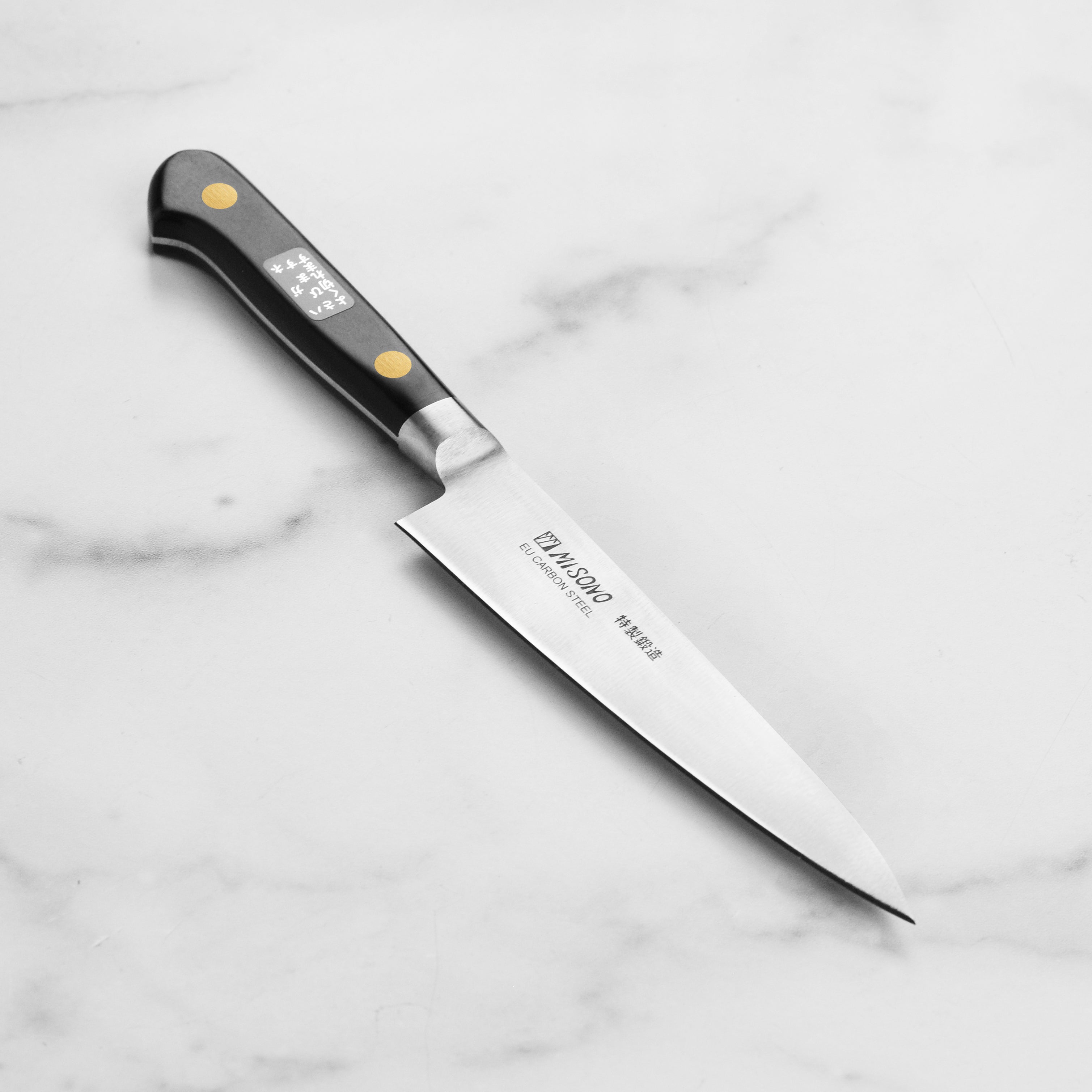 Close-up of the Misono Swedish carbon steel petty knife highlighting the sharp blade and Pakkawood handle.