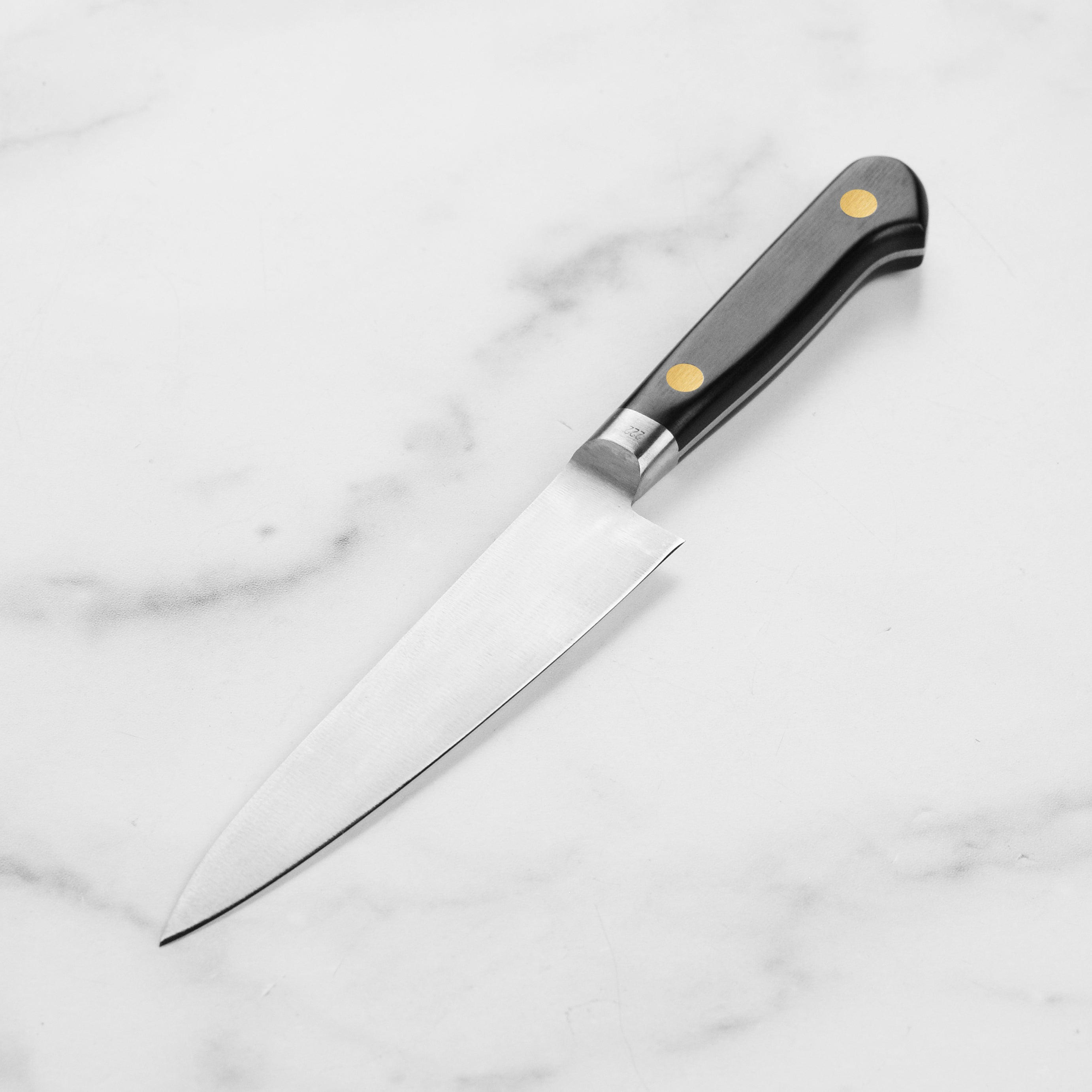 Side view of the best carbon steel kitchen knife, emphasizing the craftsmanship and double-bevel edge.