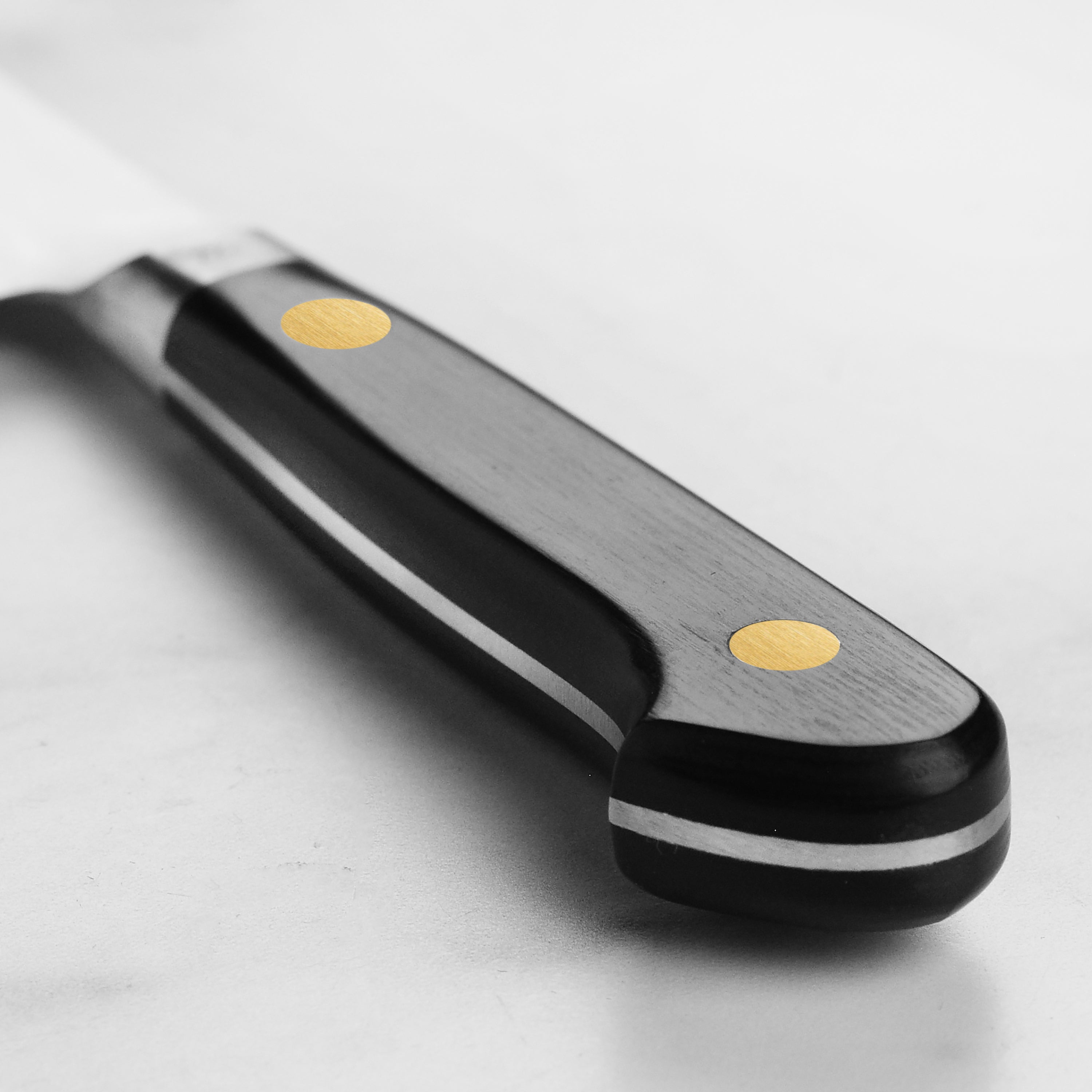 Side view of the best carbon steel kitchen knife, emphasizing the craftsmanship and double-bevel edge.