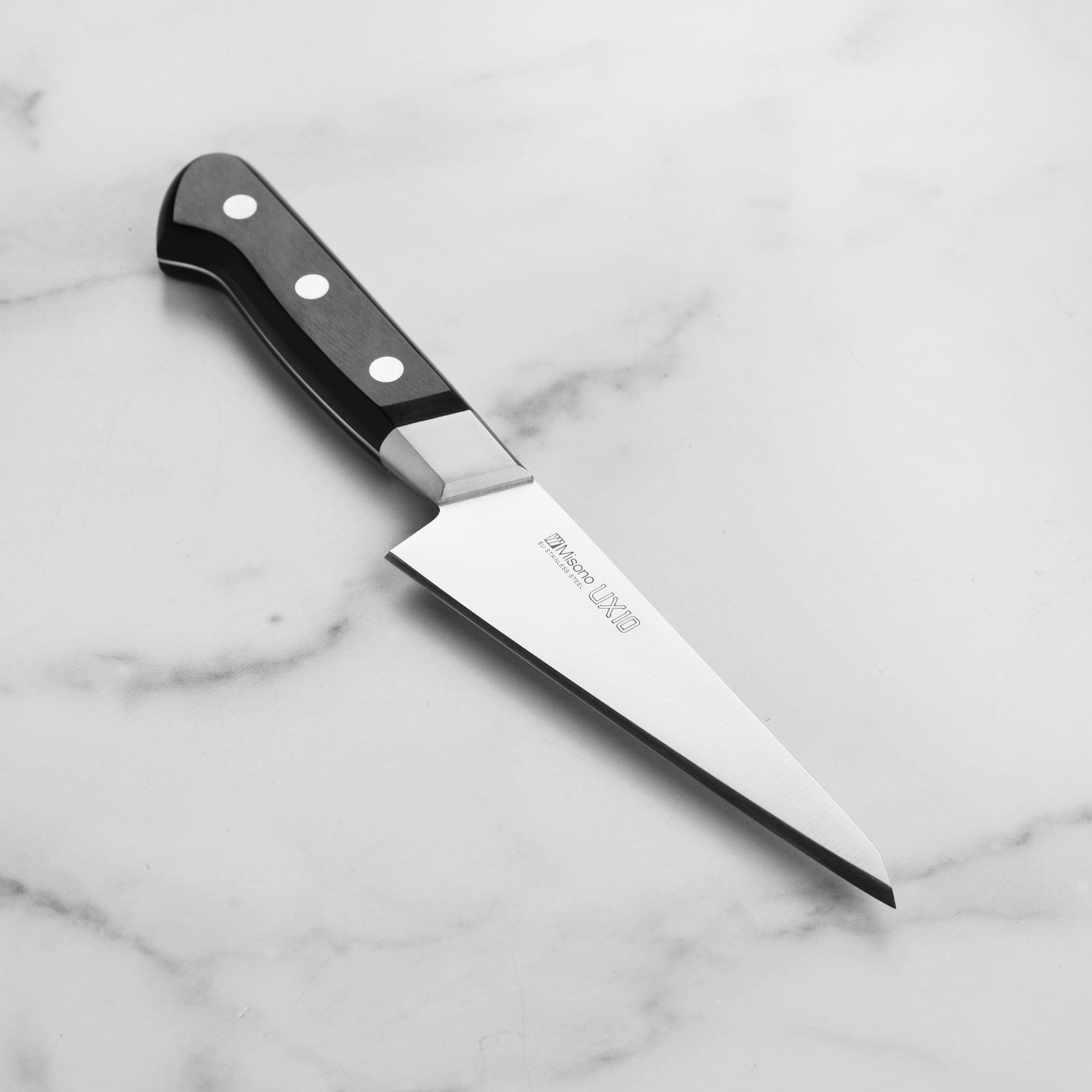 Misono UX10 Honesuki knife with black laminated handle for poultry butchery