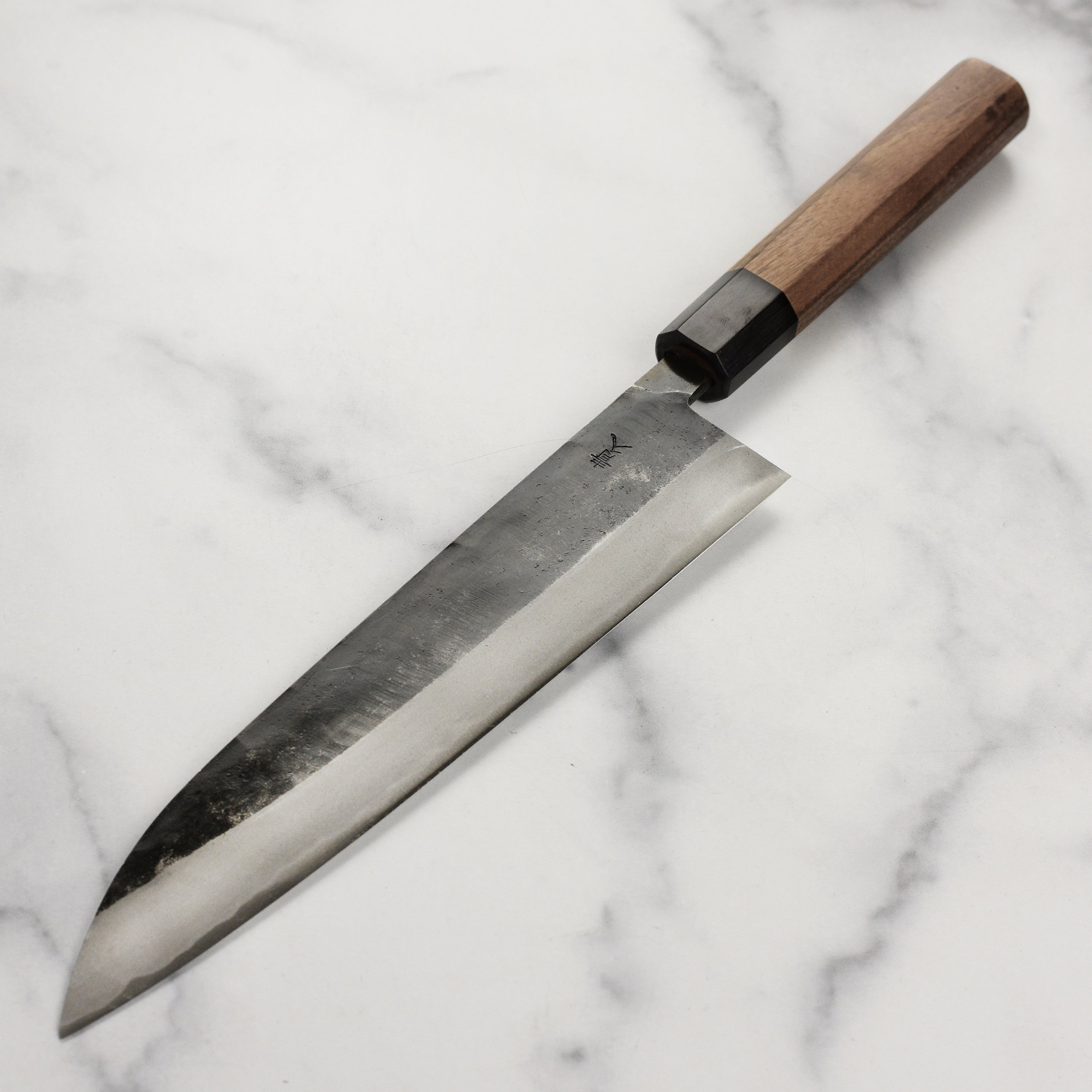 Close-up of double bevel edge of the handmade Japanese knife ready for slicing meats or vegetables