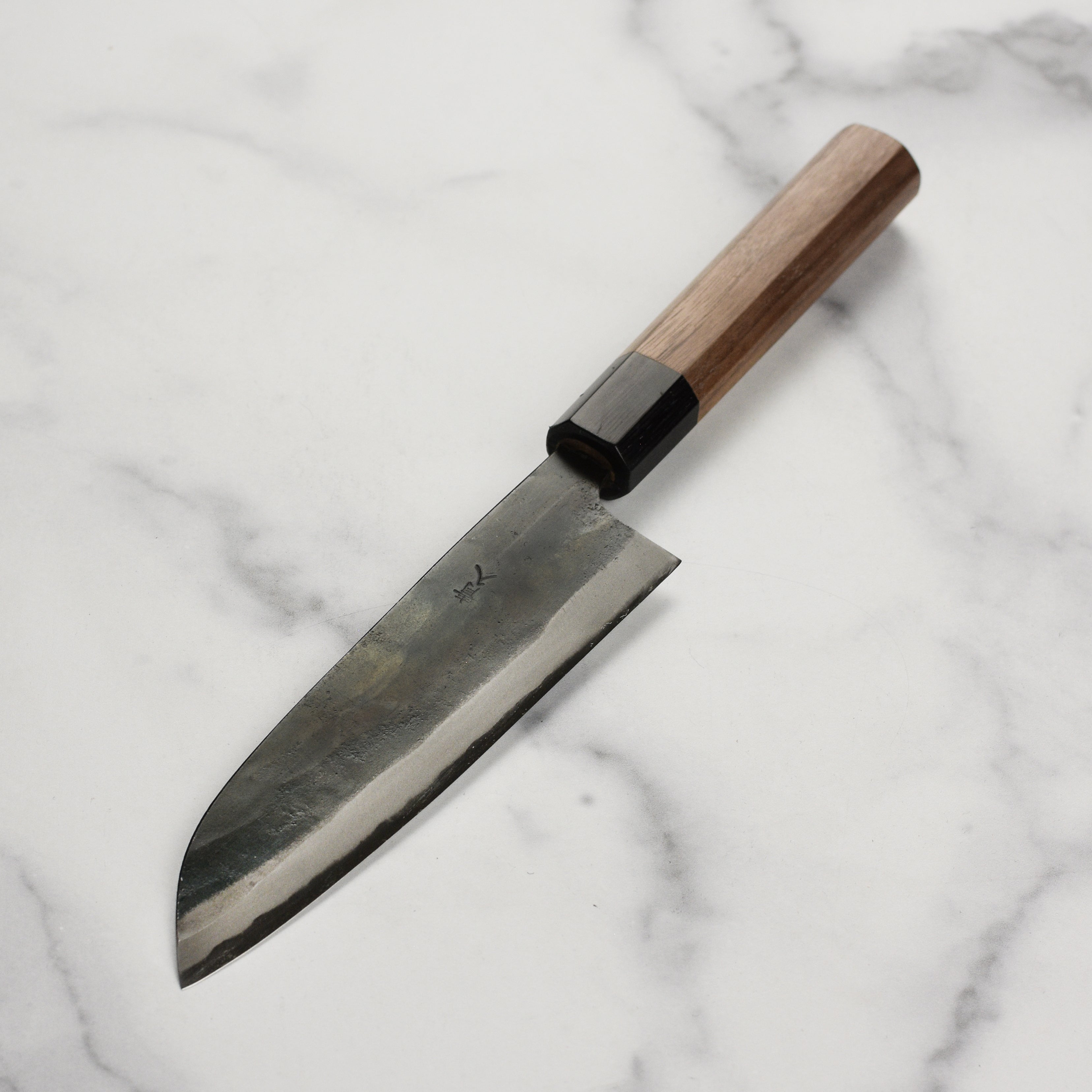 Detailed view of the walnut handle and Pakkawood ferrule on the Takayuki Santoku knife
