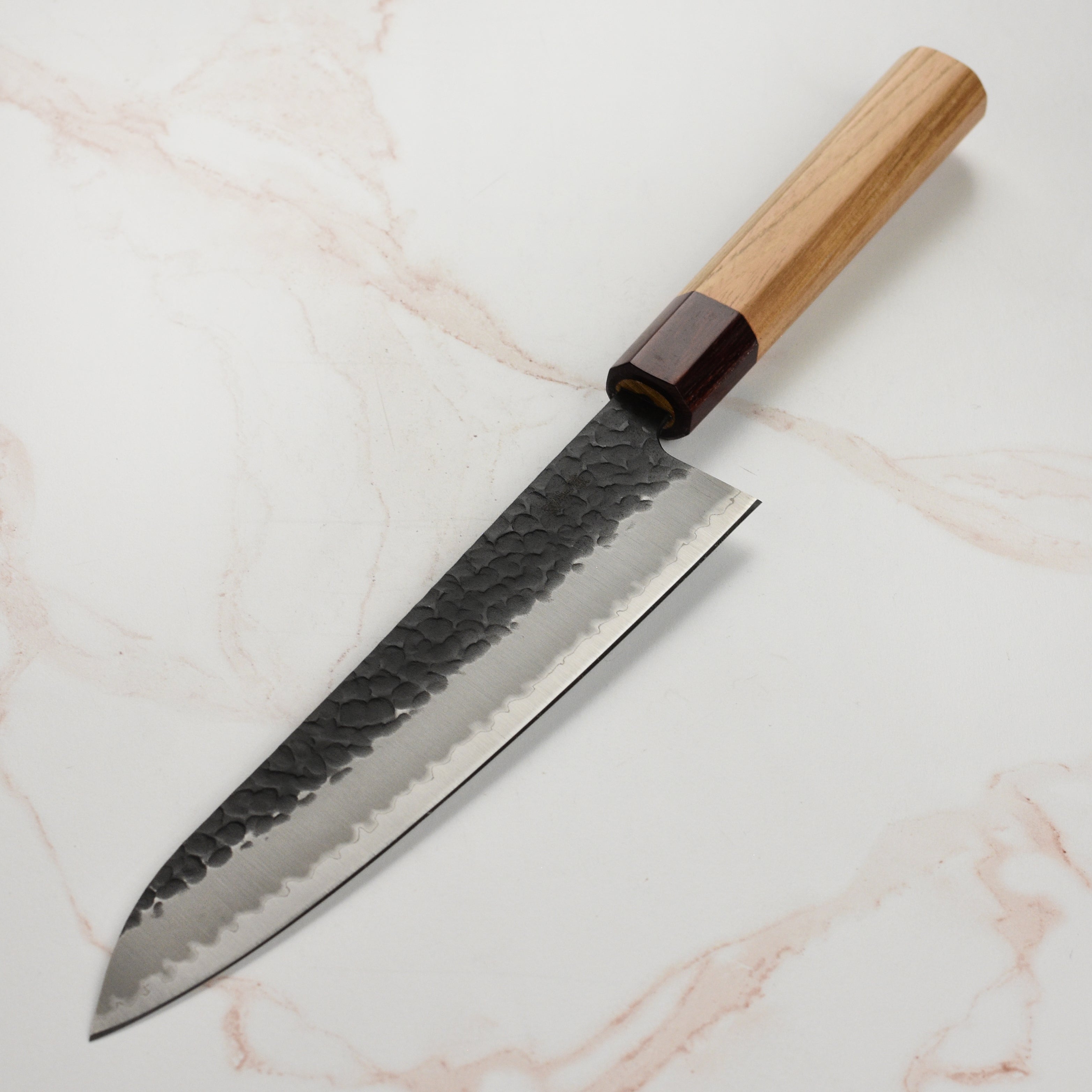 Takayuki Aogami Gyuto knife displayed in a kitchen setting, illustrating its elegance and functionality.