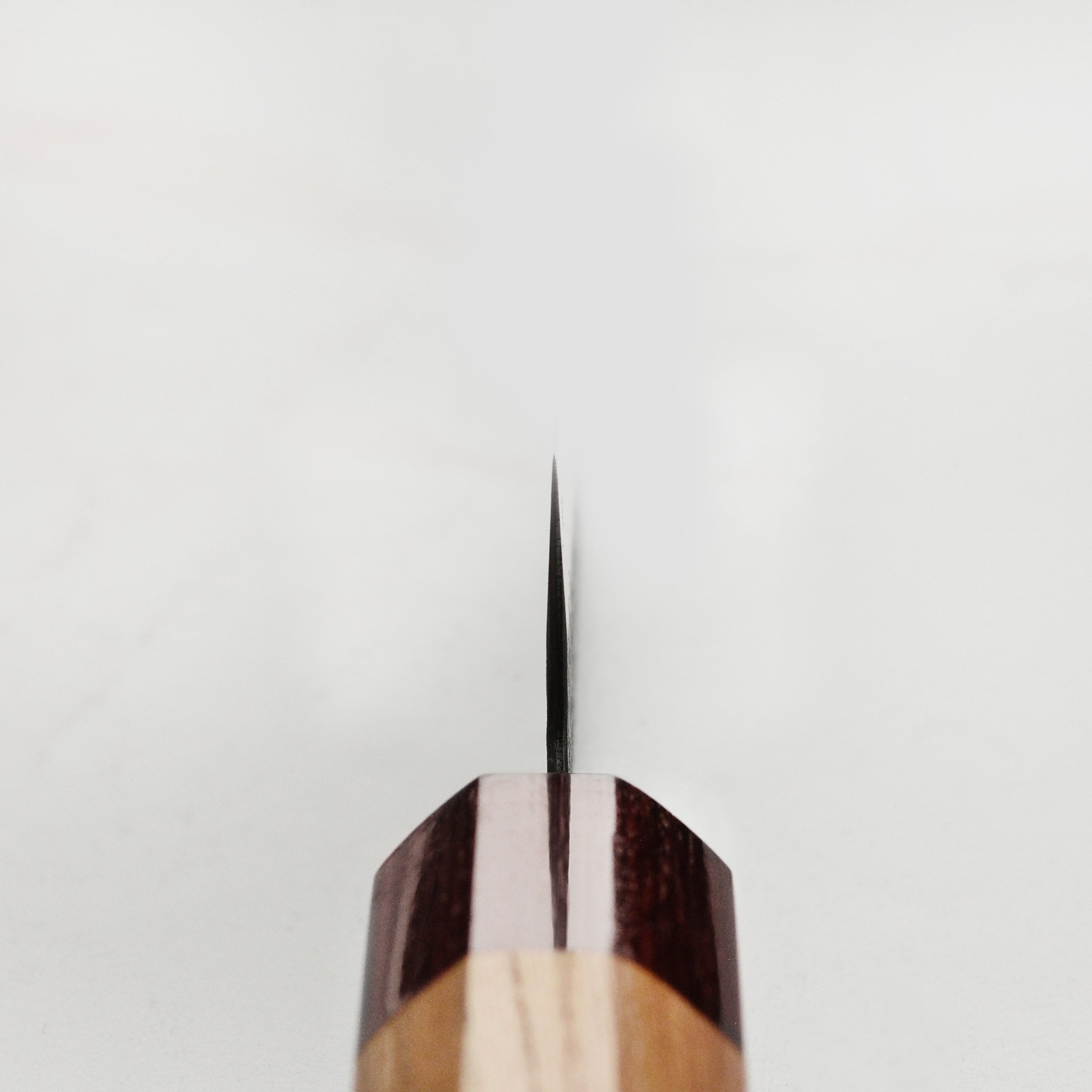 Takayuki petty knife in use, chopping vegetables on a wooden cutting board
