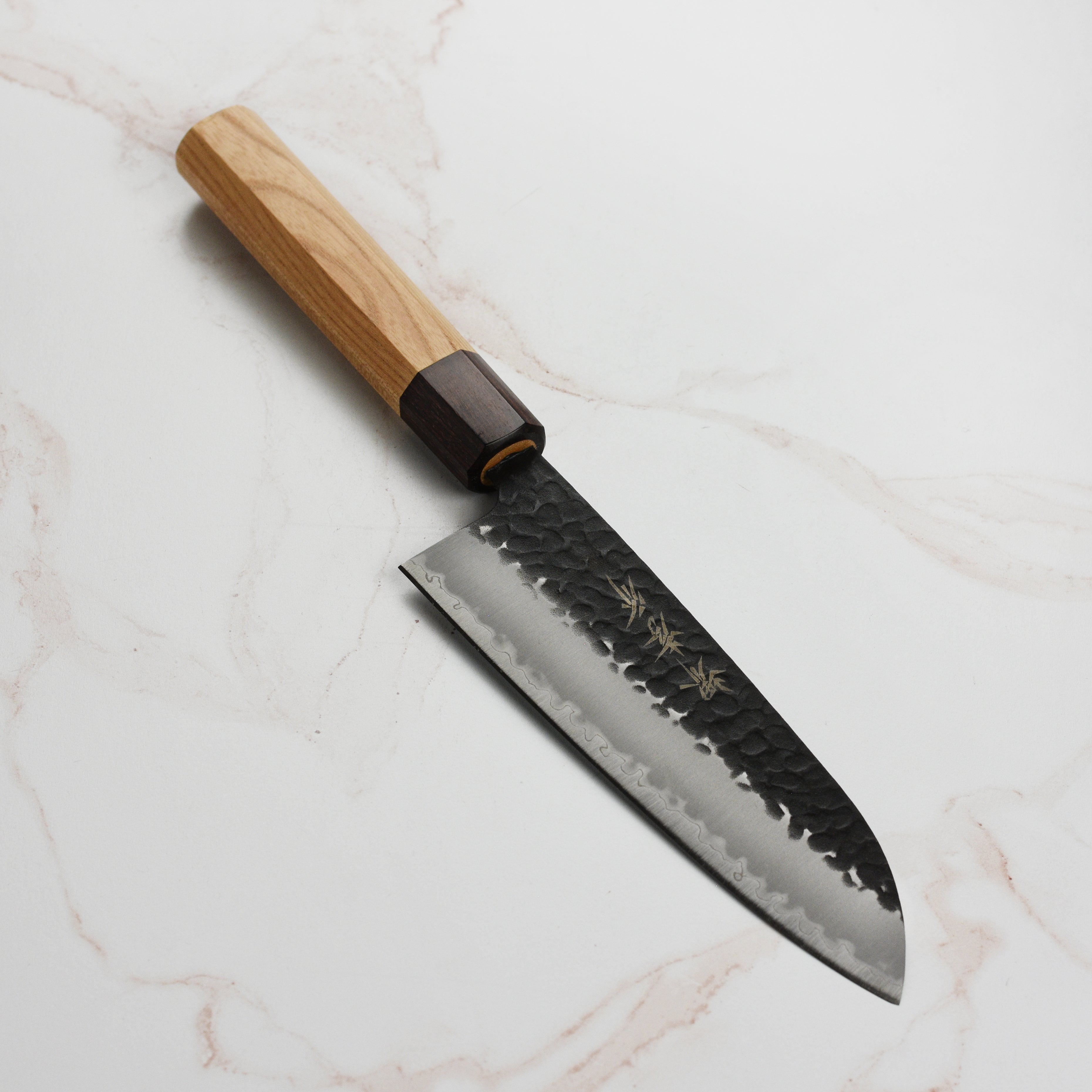 Close-up of Takayuki Aogami Super Santoku knife blade with kurouchi finish