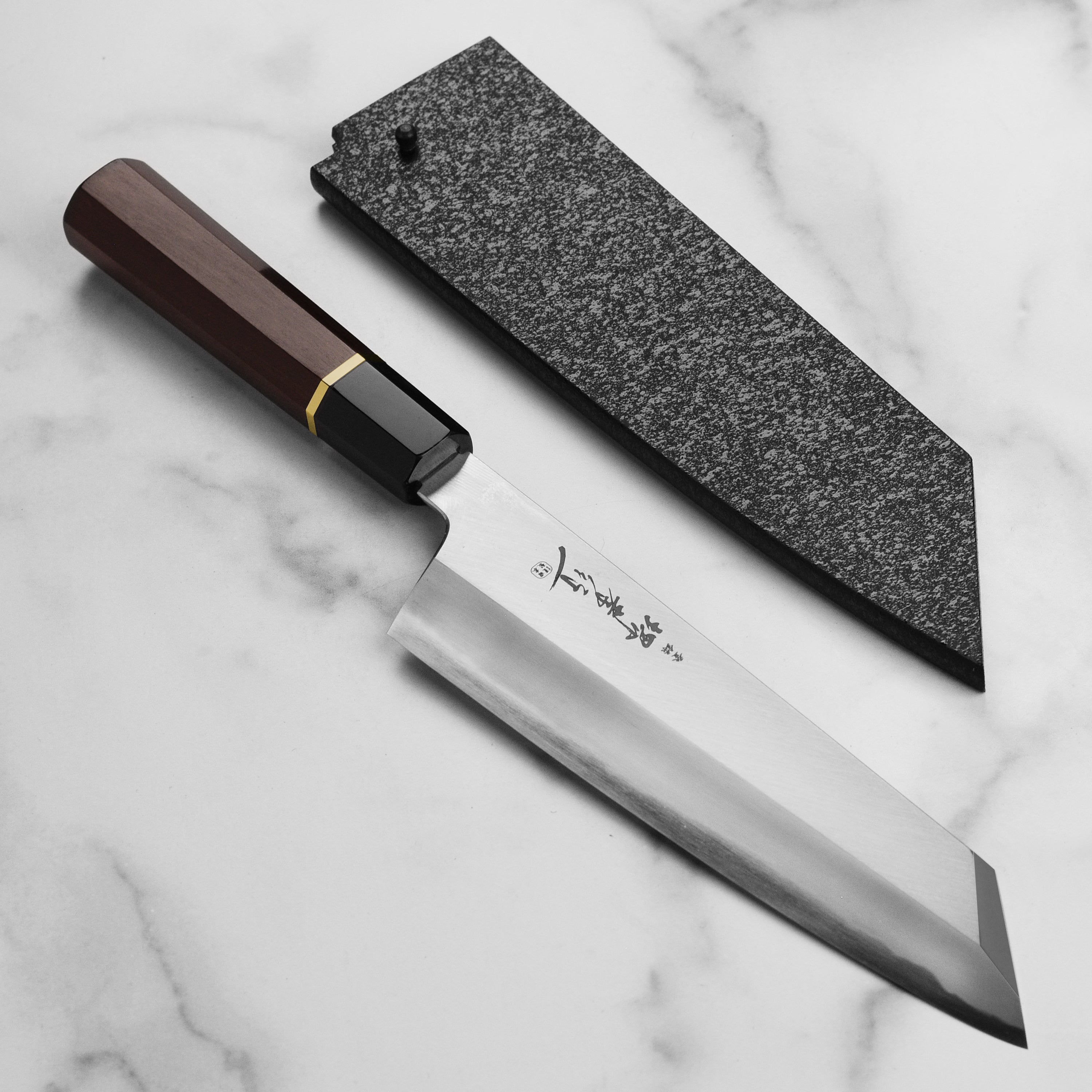 Side view of the Sakai Master Aogami #2 Gyuto Chef Knife showcasing its sharp blade and elegant handle.
