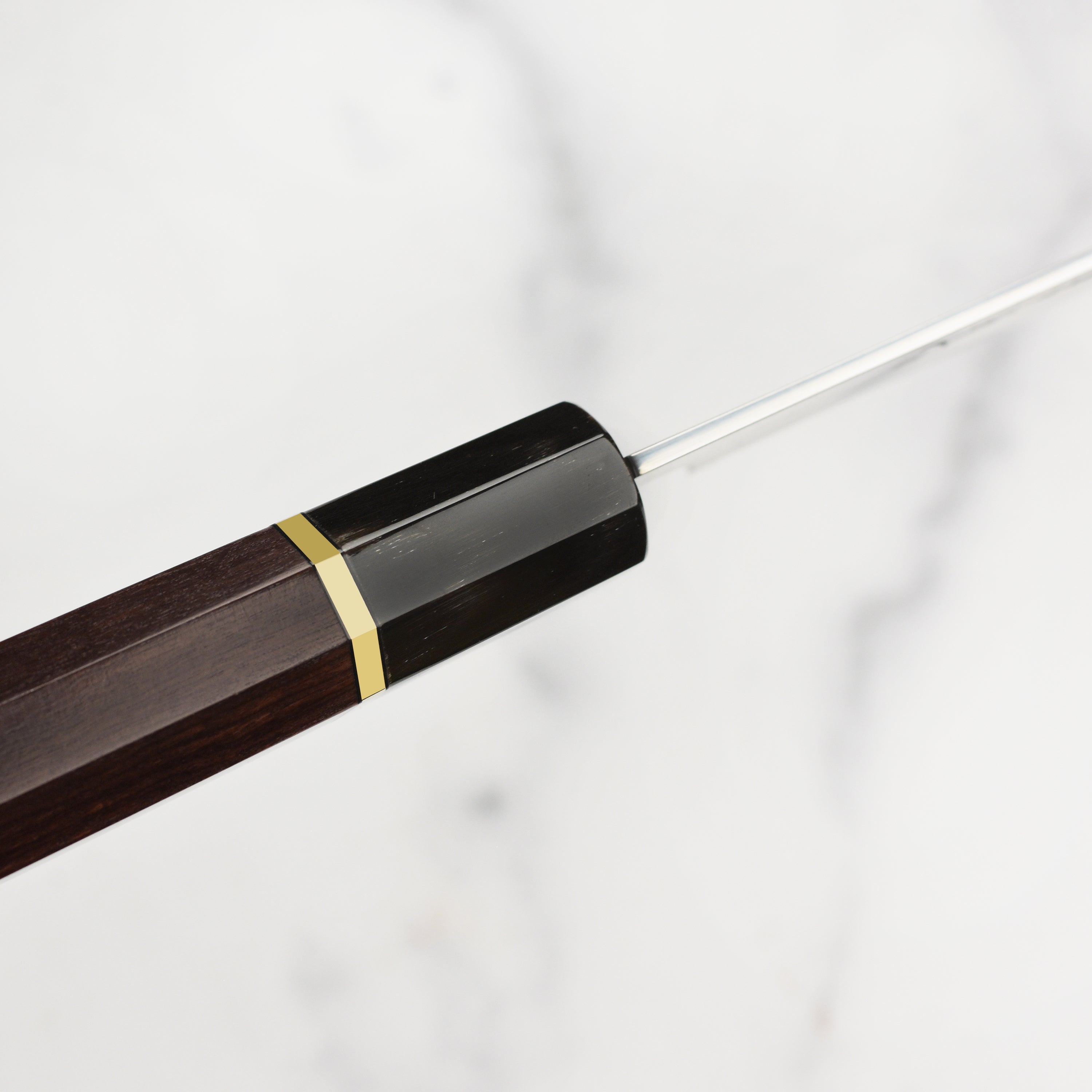Side view of the carbon steel gyuto knife, emphasizing the Kengata tip and matte finish.