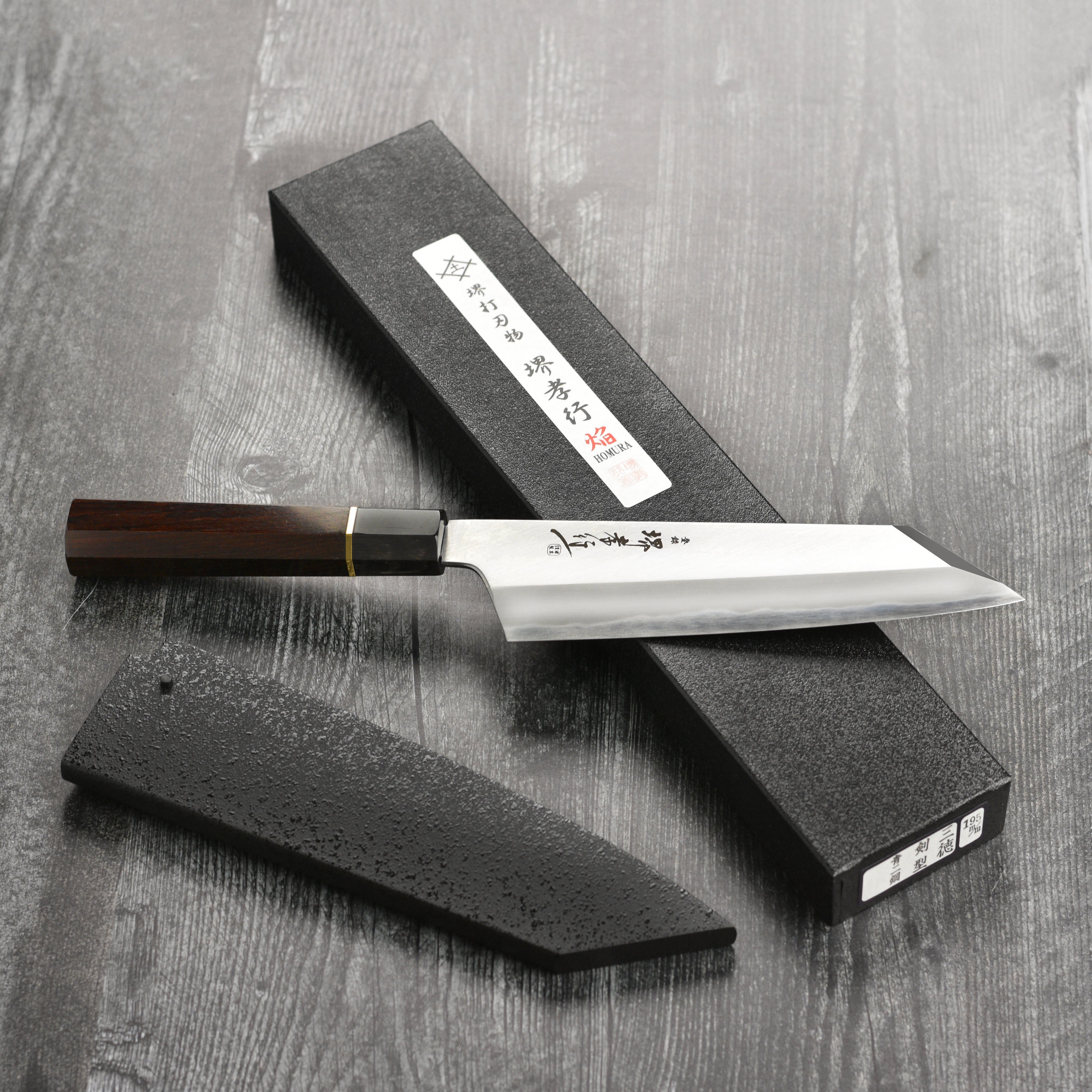 Side view of the carbon steel gyuto knife, emphasizing the Kengata tip and matte finish.