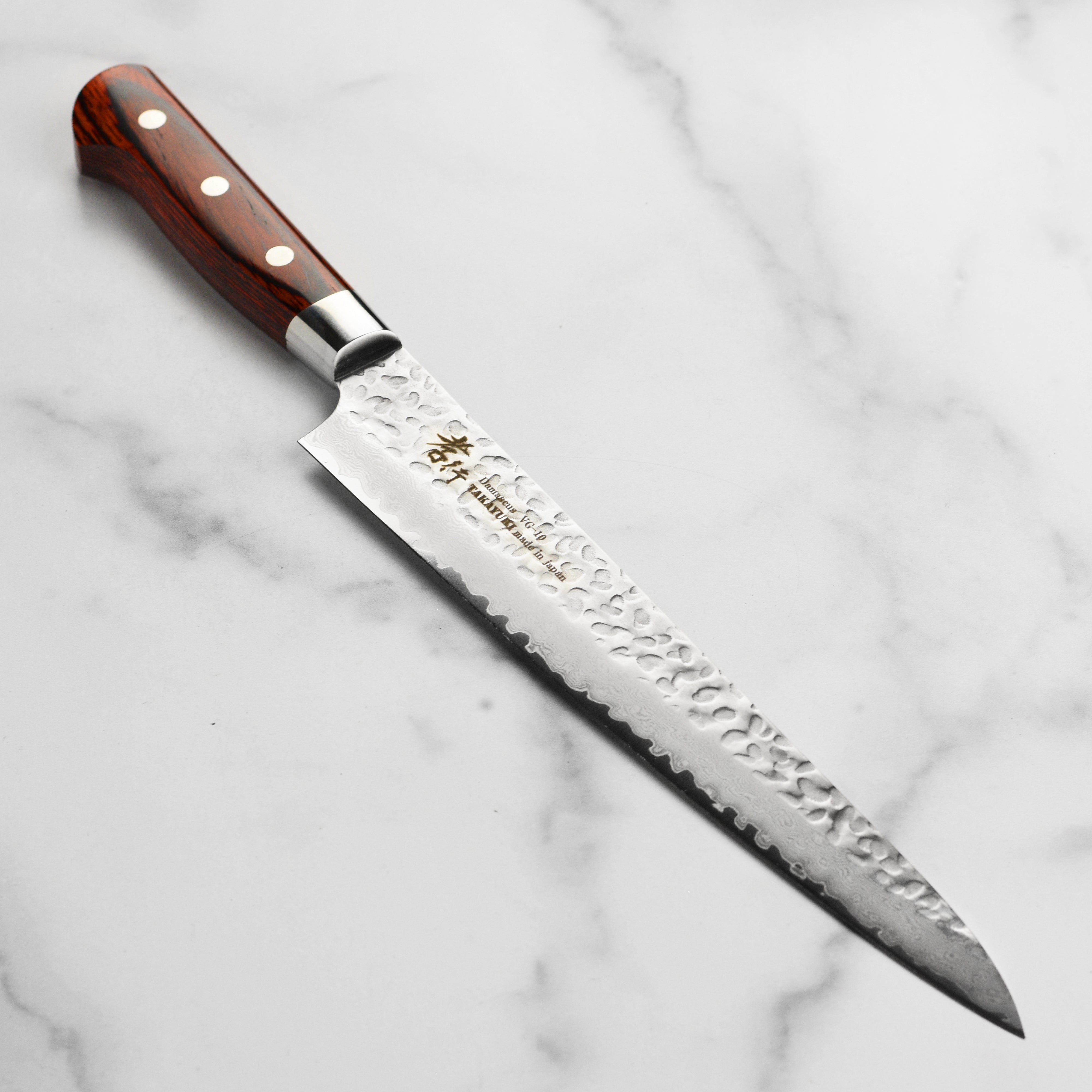 Takayuki Hammered Damascus Sujihiki Knife showcasing the beautifully crafted blade and handle.