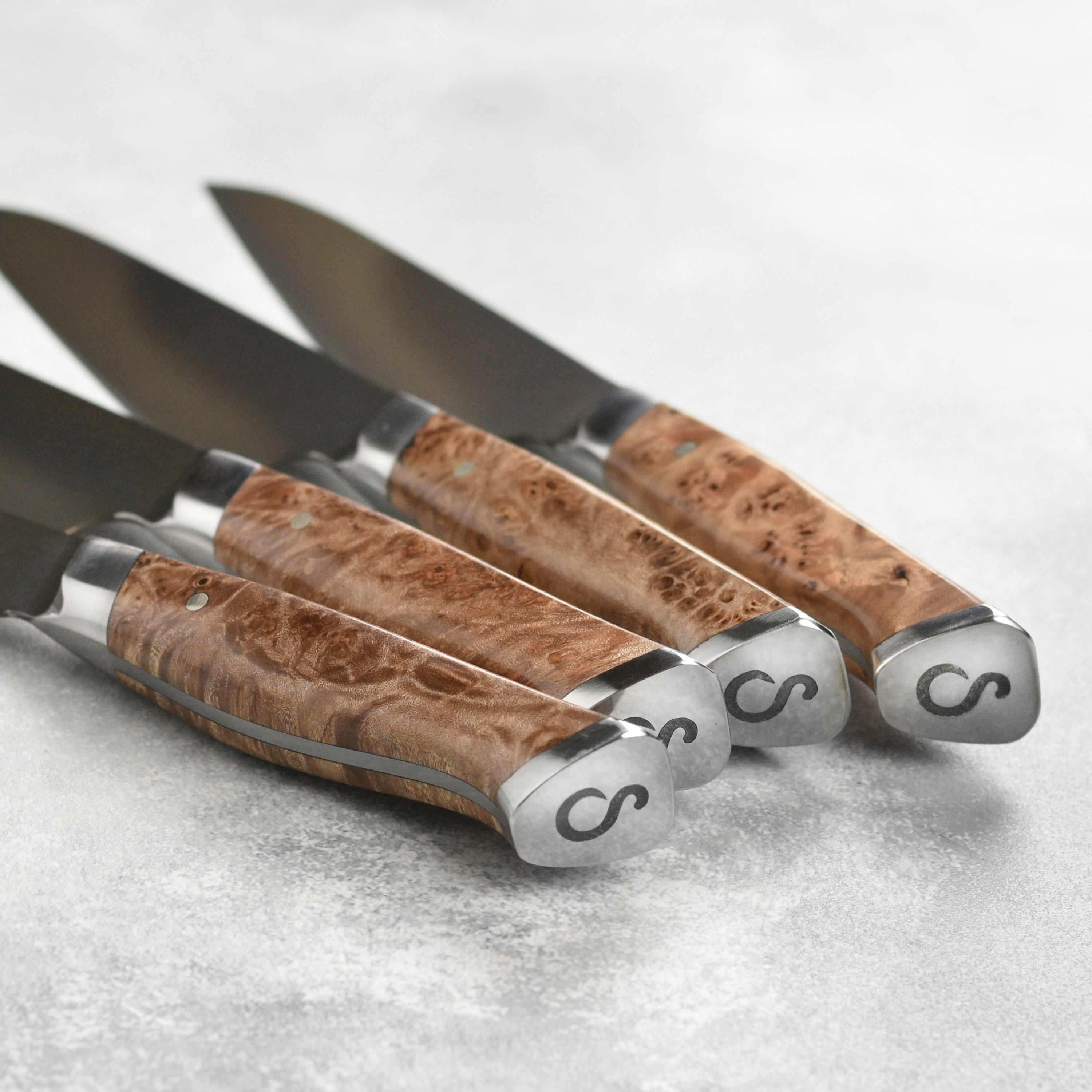 Steelport steak knife set with case displayed on a kitchen counter.