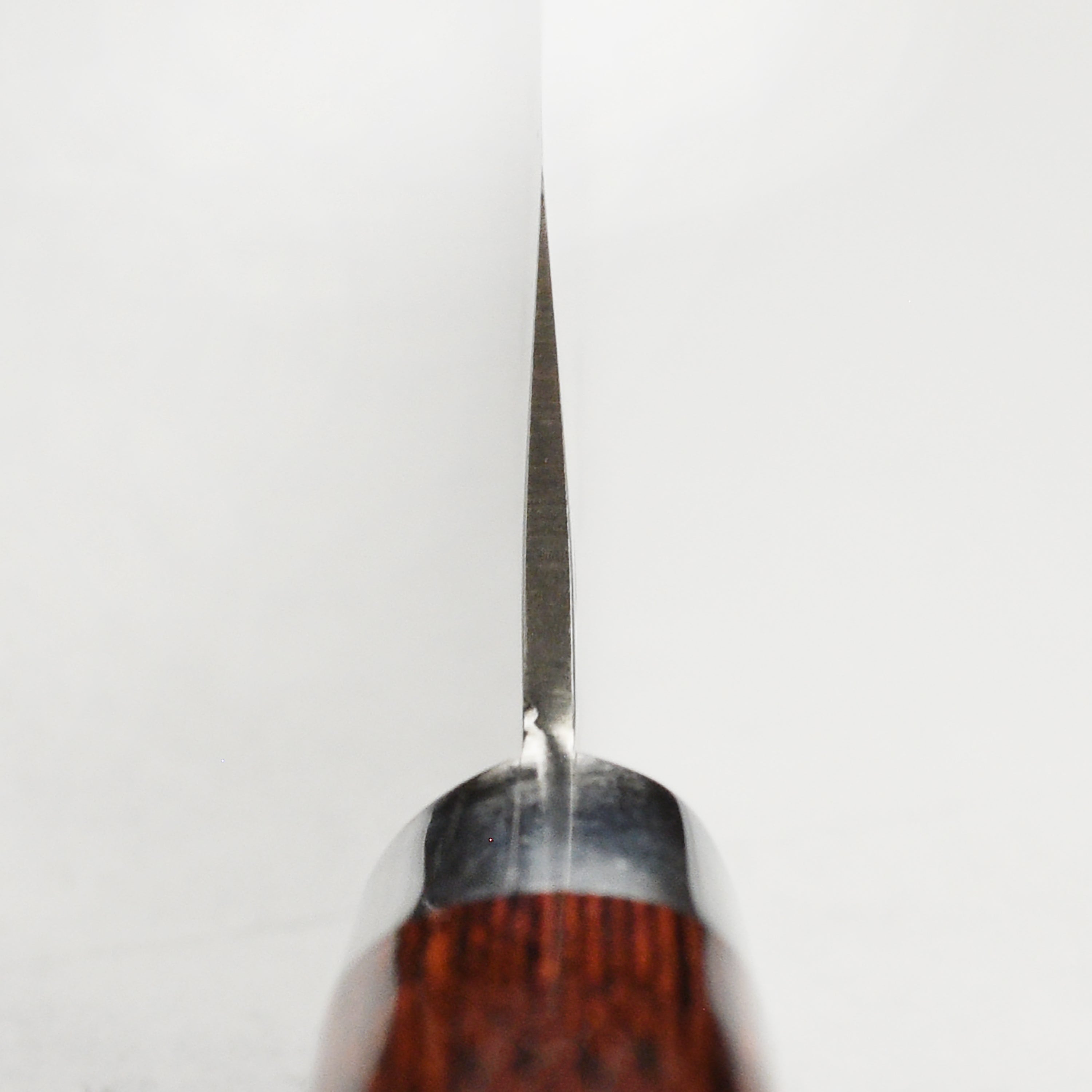 Elegant display of the Sakai Mastercraft Damascus petty knife, emphasizing its mahogany Pakkawood handle.