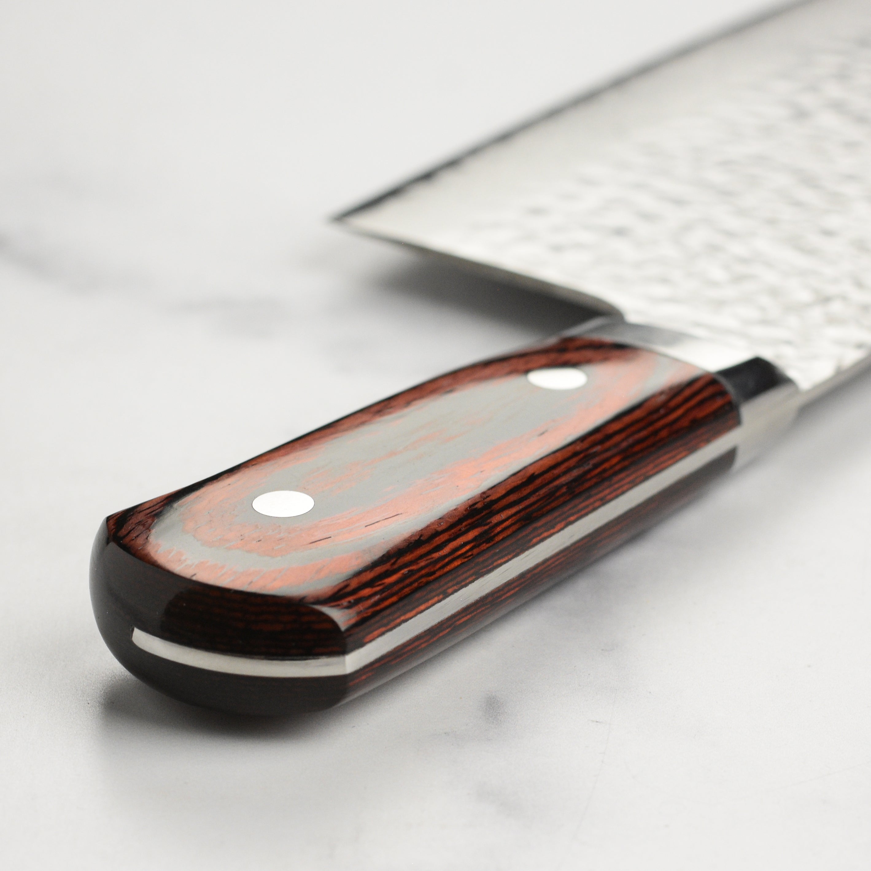 Close-up of the Pakkawood handle of the Sakai Damascus chefs knife for a comfortable grip.