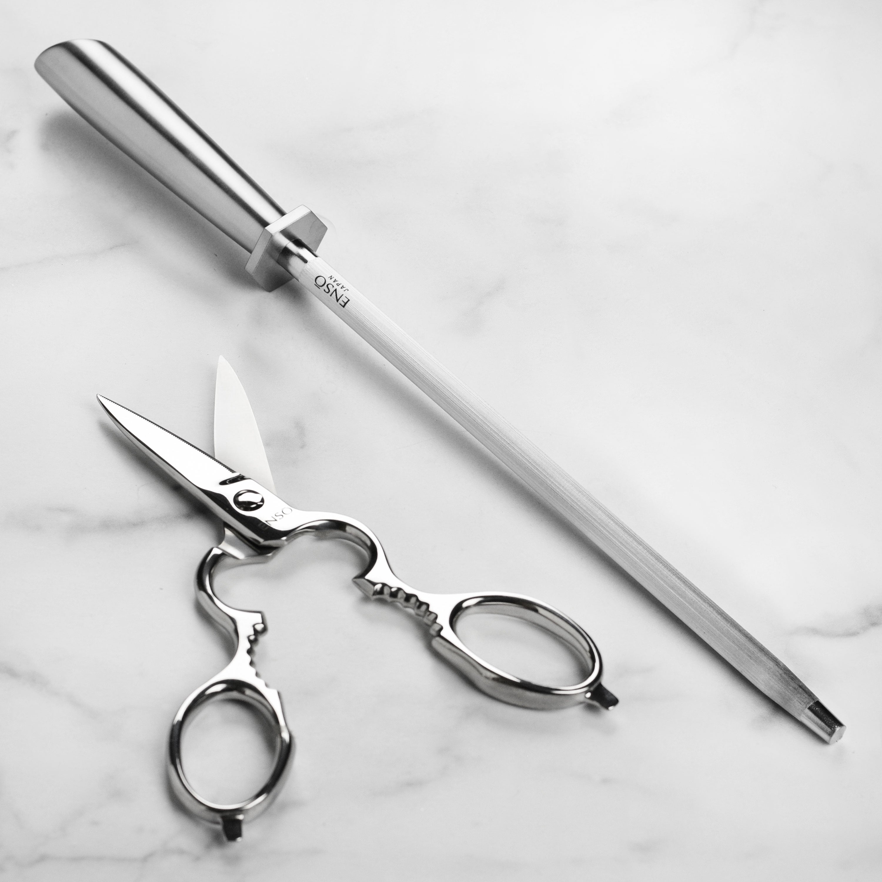 A chef using the Seki Master knife set to prepare fresh vegetables in a modern kitchen.