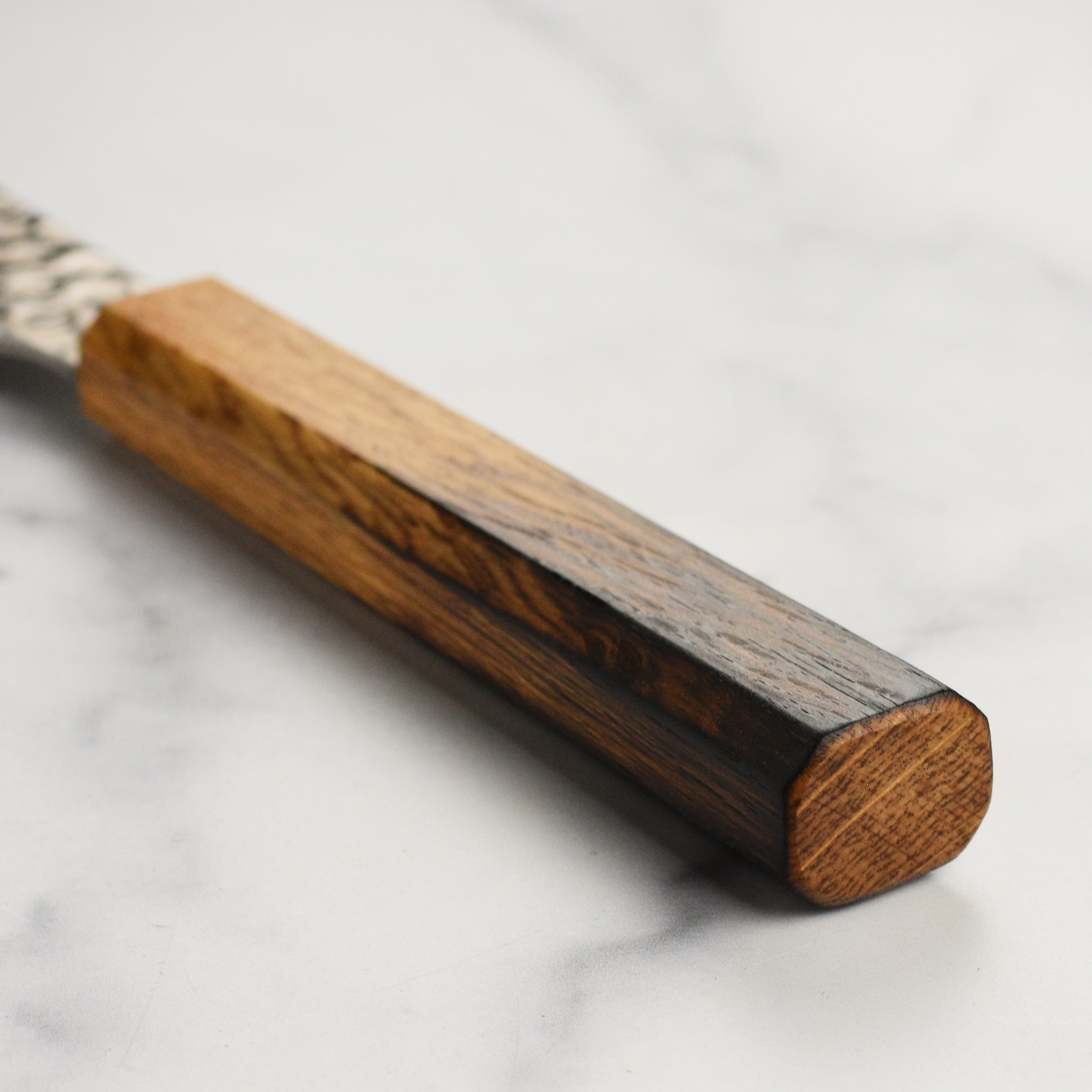 Elegant Sakai Tsuchime knife displayed on a wooden cutting board, highlighting its craftsmanship.