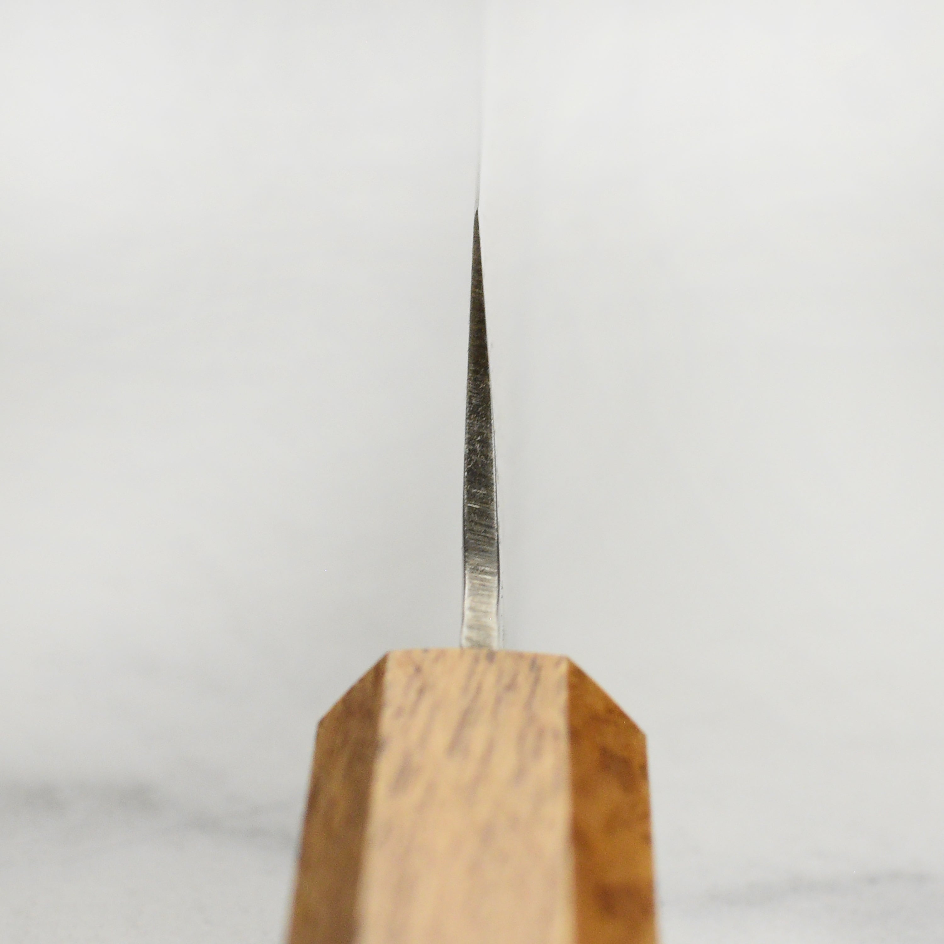 Close-up of the Premium Sakimaru-Yanagiba knife blade, highlighting the Damascus steel pattern.