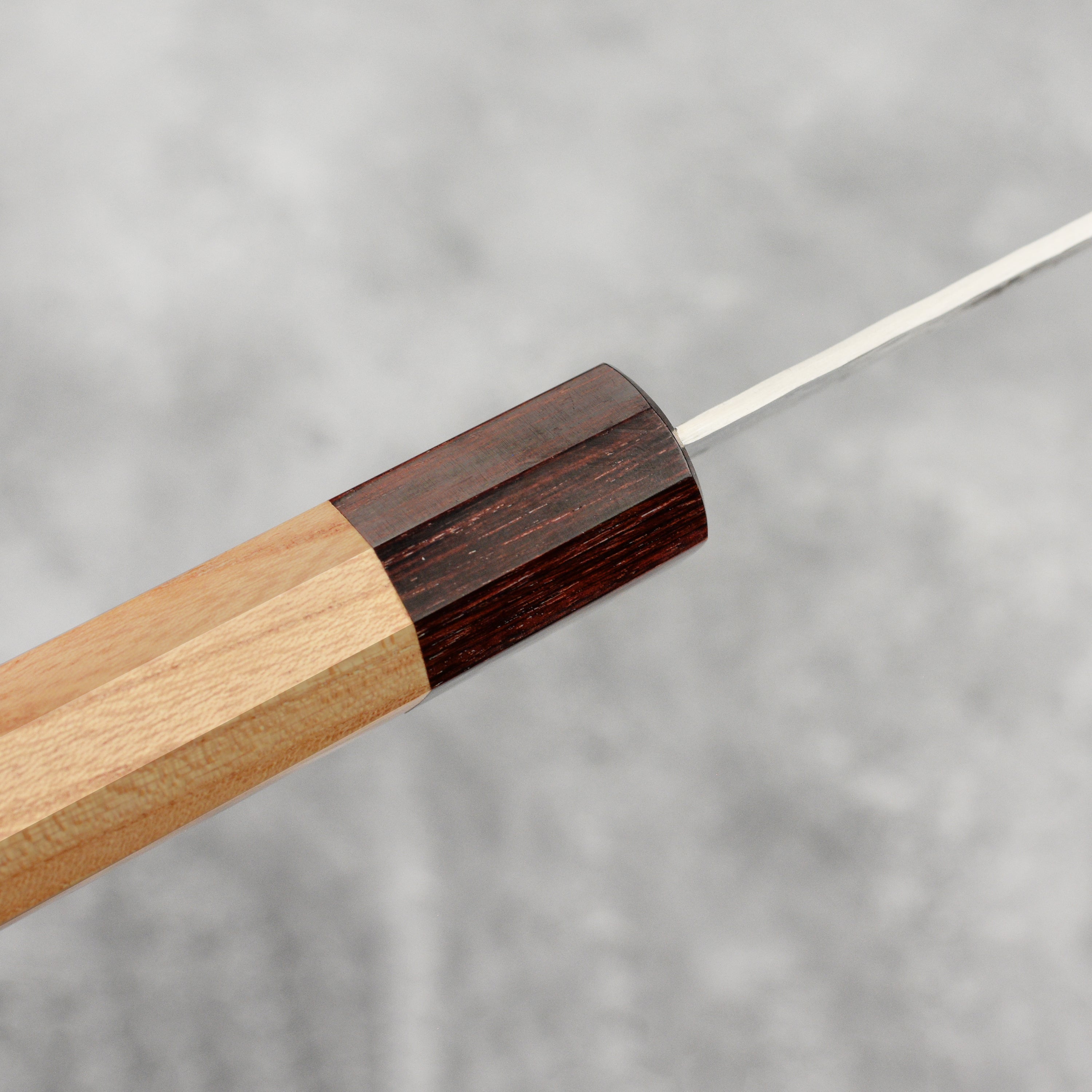 The premium Japanese damascus petty knife in action, cutting fresh vegetables on a wooden chopping board.