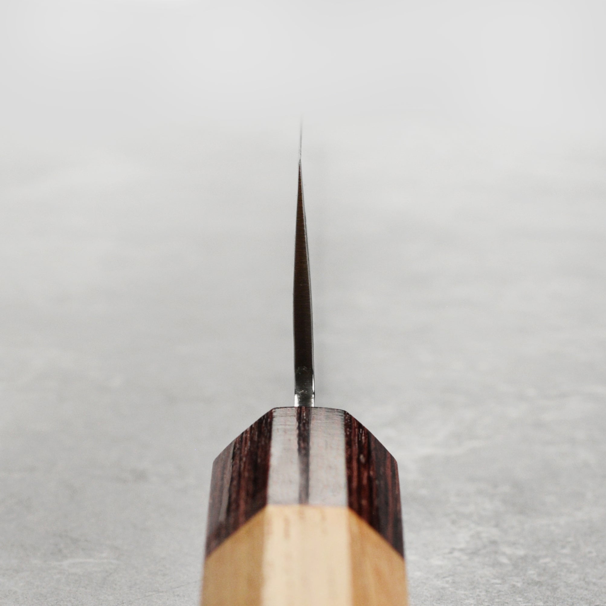 Close-up of the 6.3-inch Takayuki Nakiri knife highlighting the Damascus steel pattern and sharp edge