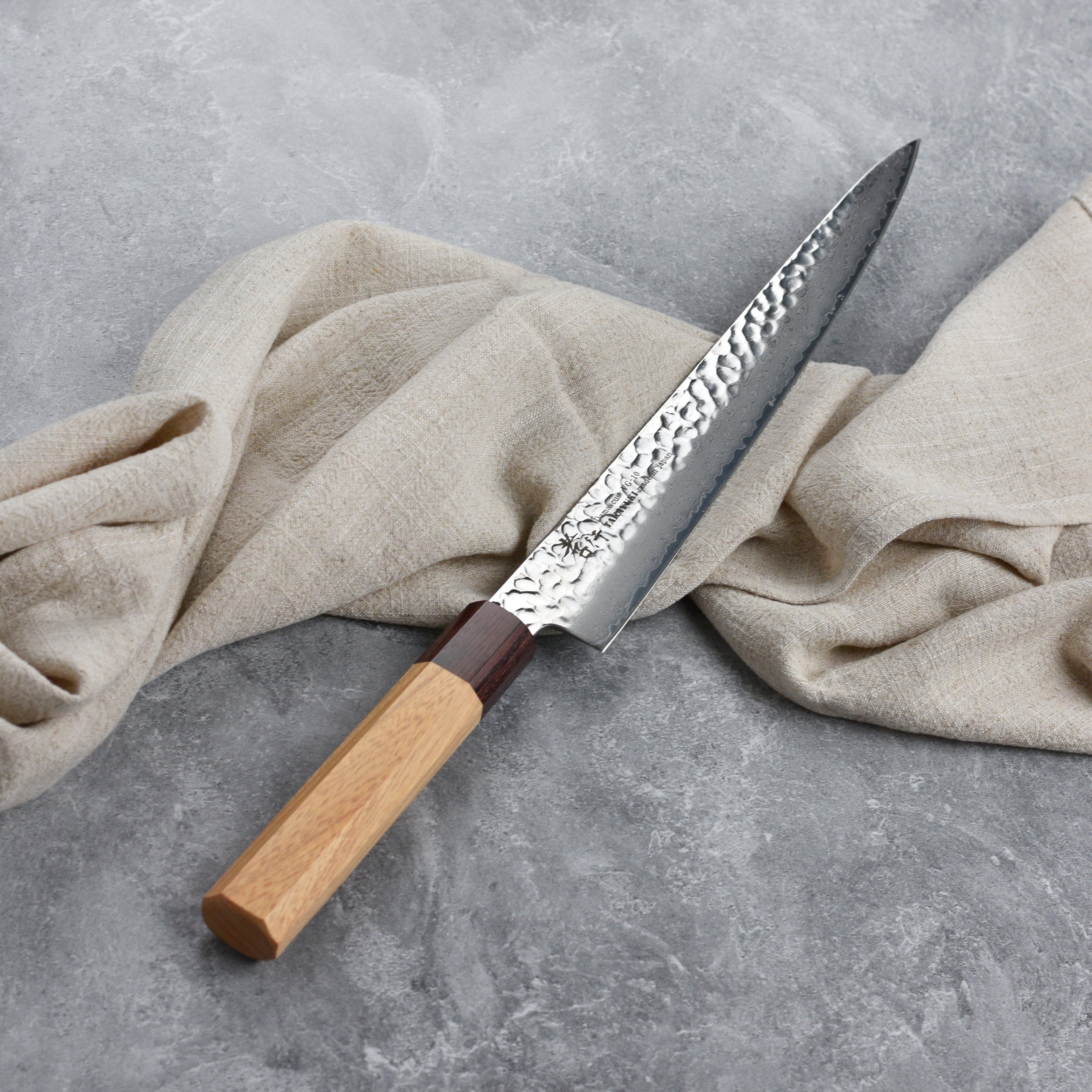 The ergonomic Zelkova wood handle of the Takayuki sujihiki knife, highlighting its craftsmanship.