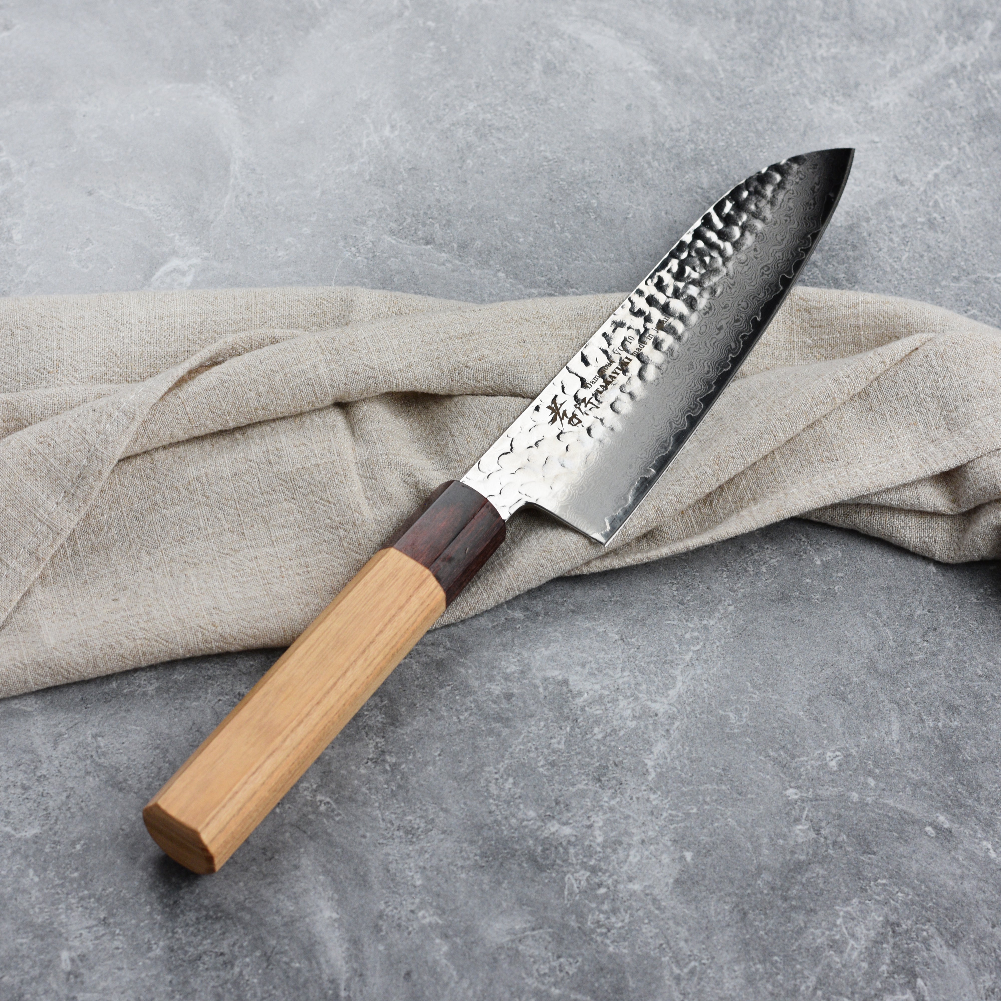 Side view of the octagonal Zelkova wood handle of the Takayuki Santoku knife.