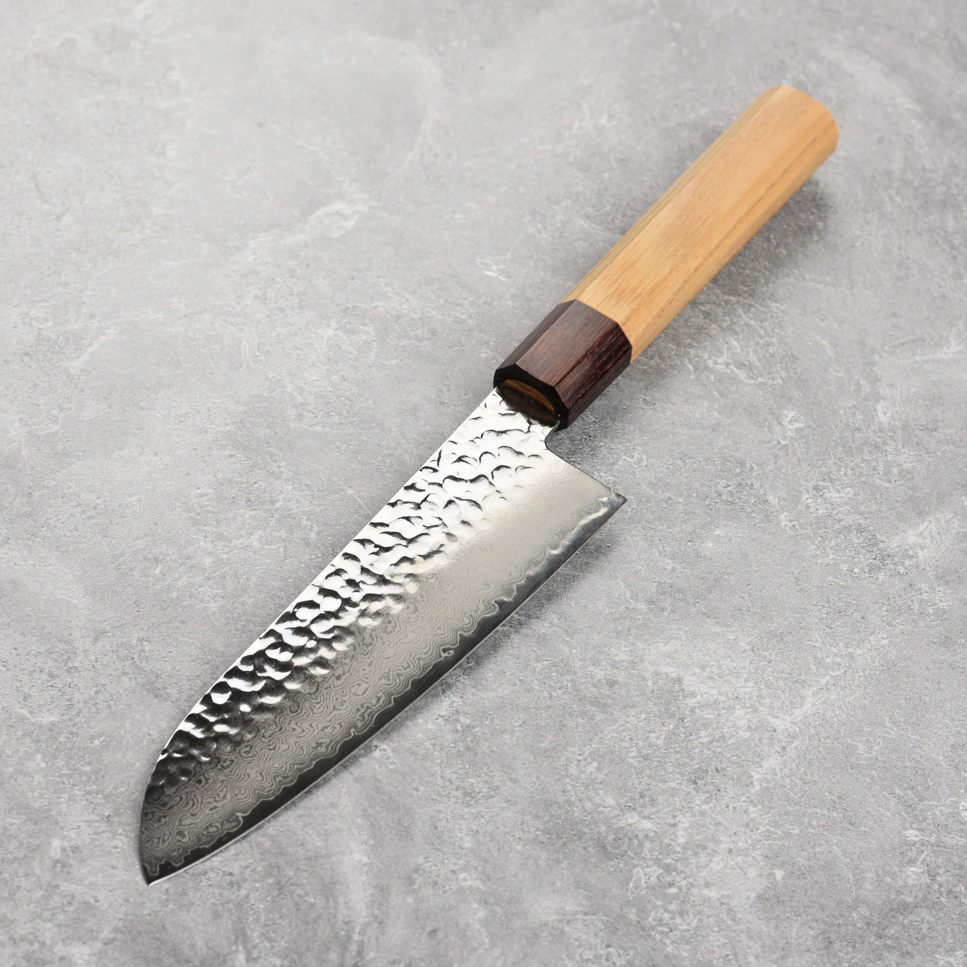 Close-up of the 33-layer hammered Damascus steel blade of the Santoku knife.