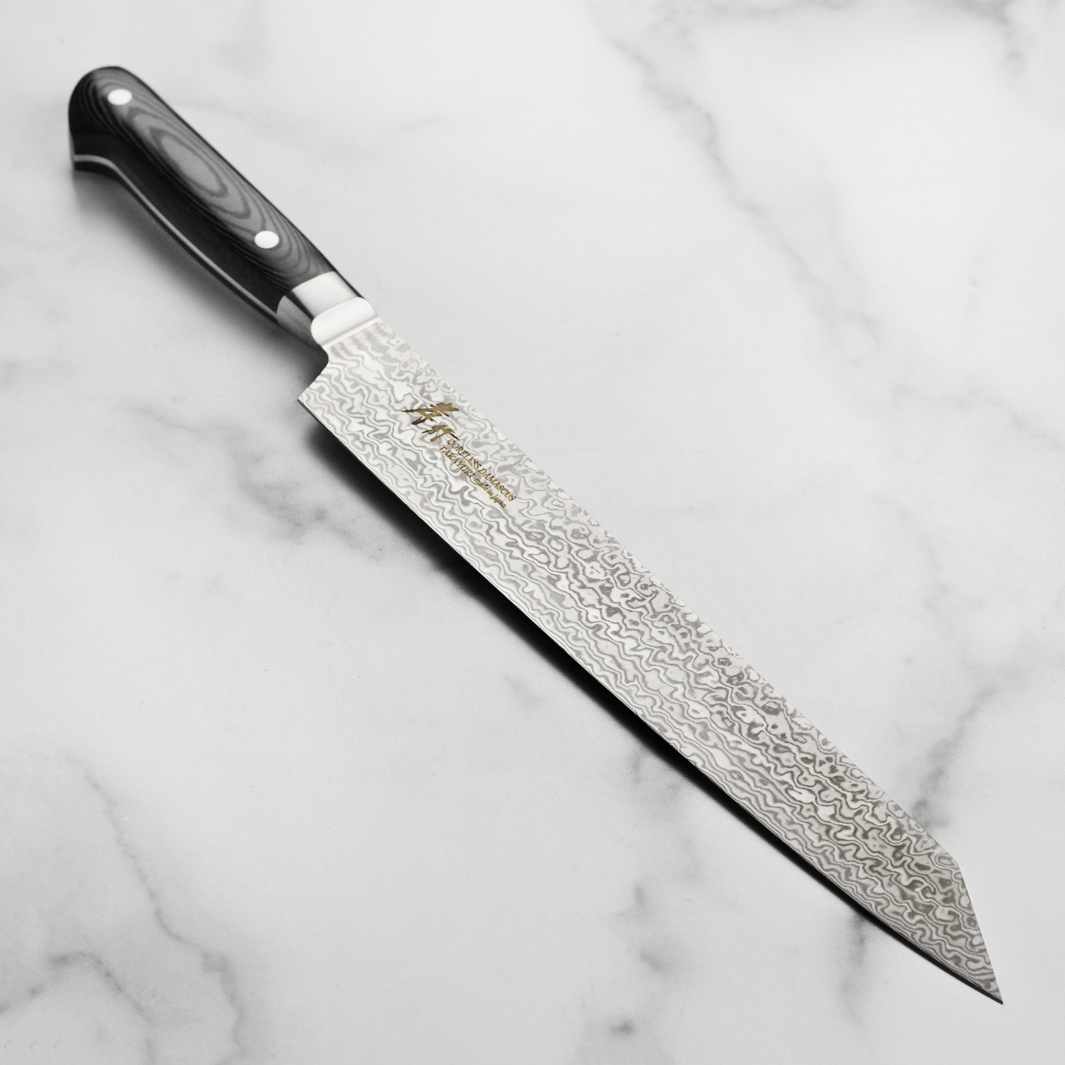 Takayuki Japanese kitchen knife with damascus blade and full-tang handle