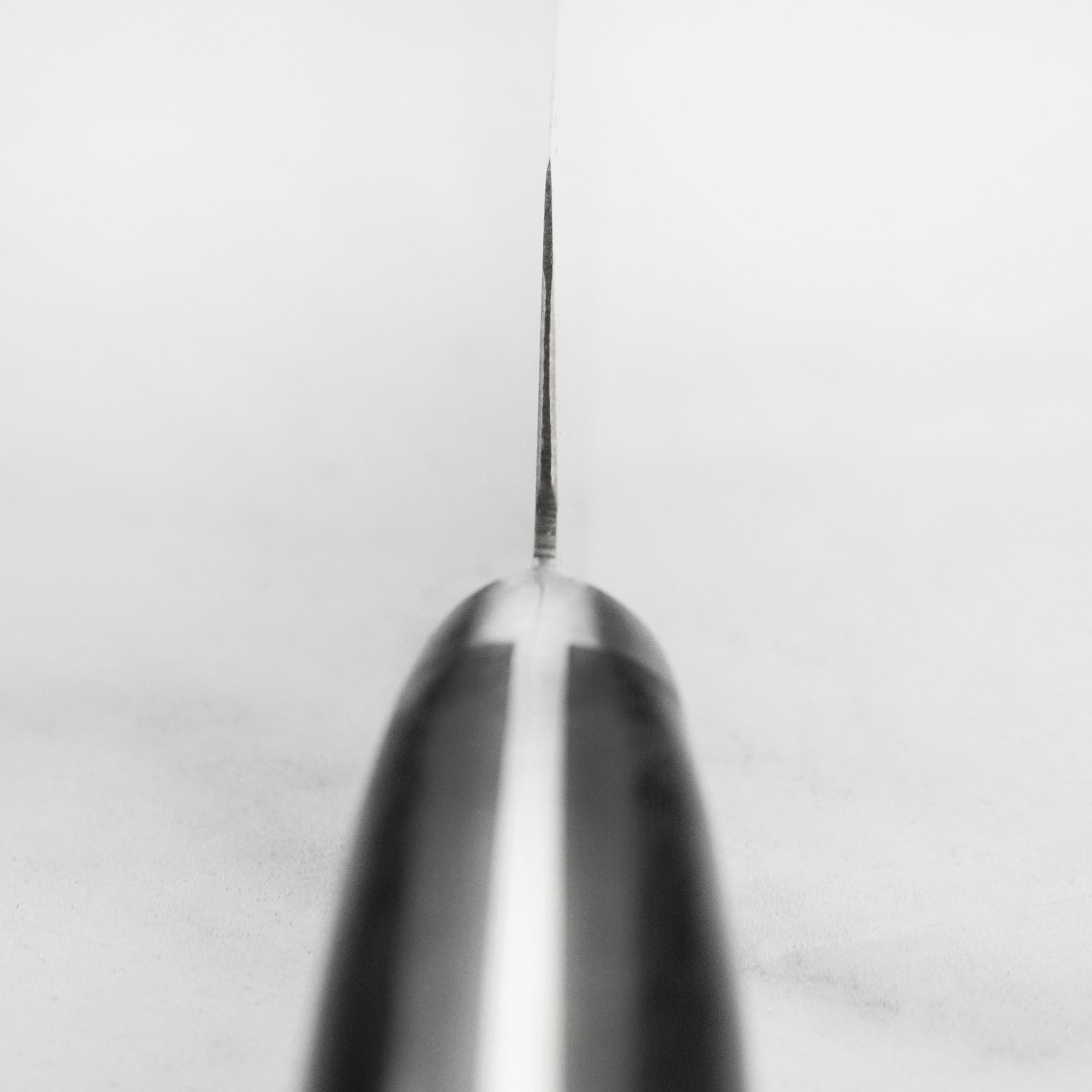 Close-up of the VG10 coreless damascus steel sujihiki for precision slicing