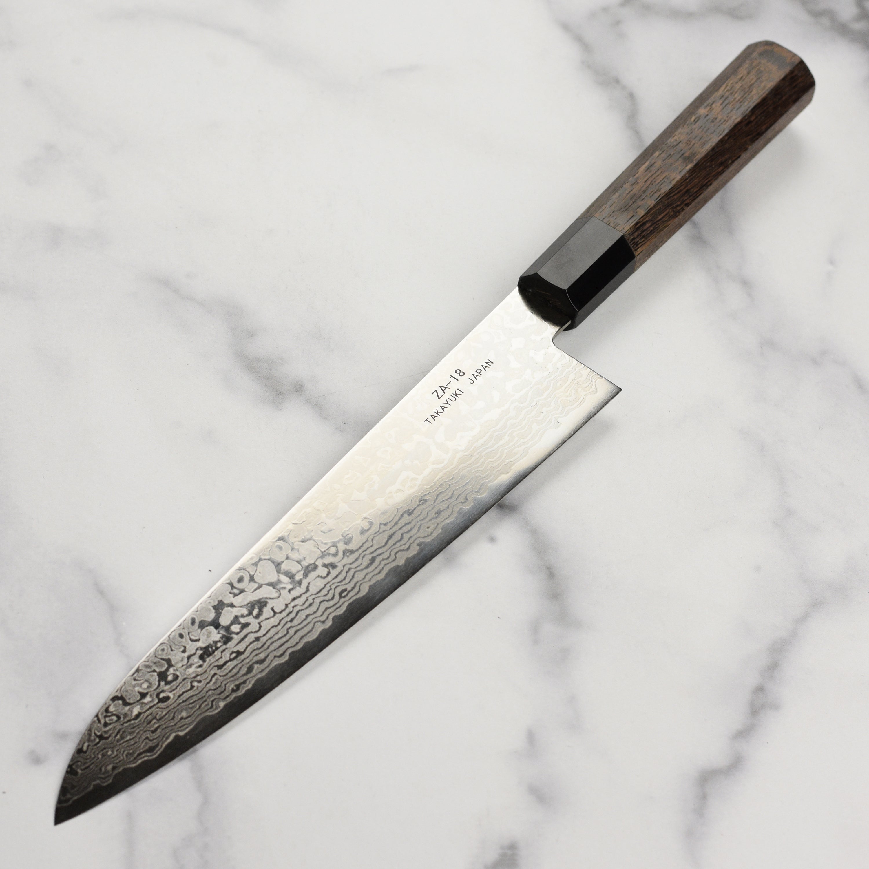 Close-up of the Wenge wood handle and buffalo horn ferrule of the Sakai Ginga knife.