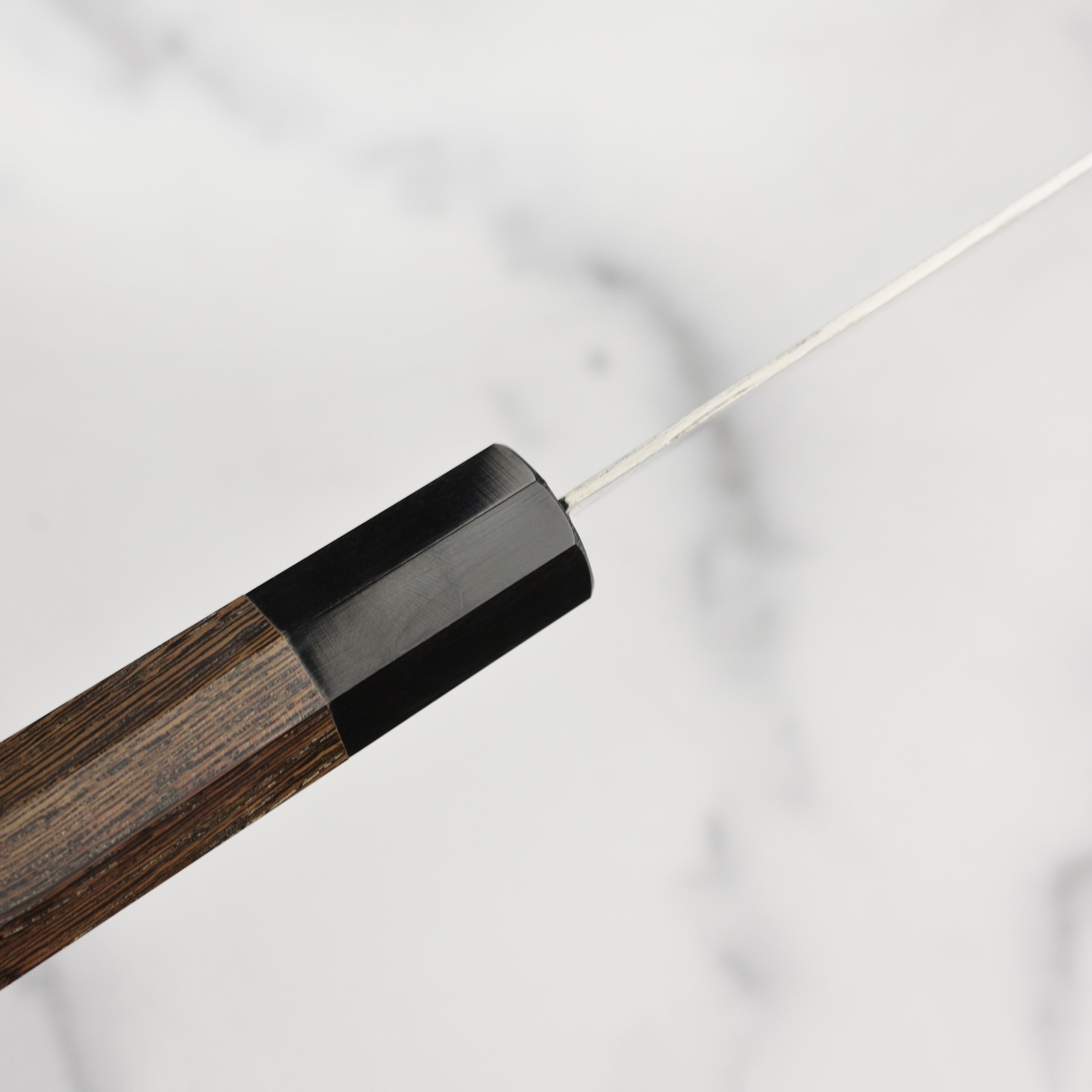 Detailed shot of the wenge wood handle and buffalo horn ferrule on the Takayuki Ginga ZA-18 petty knife.