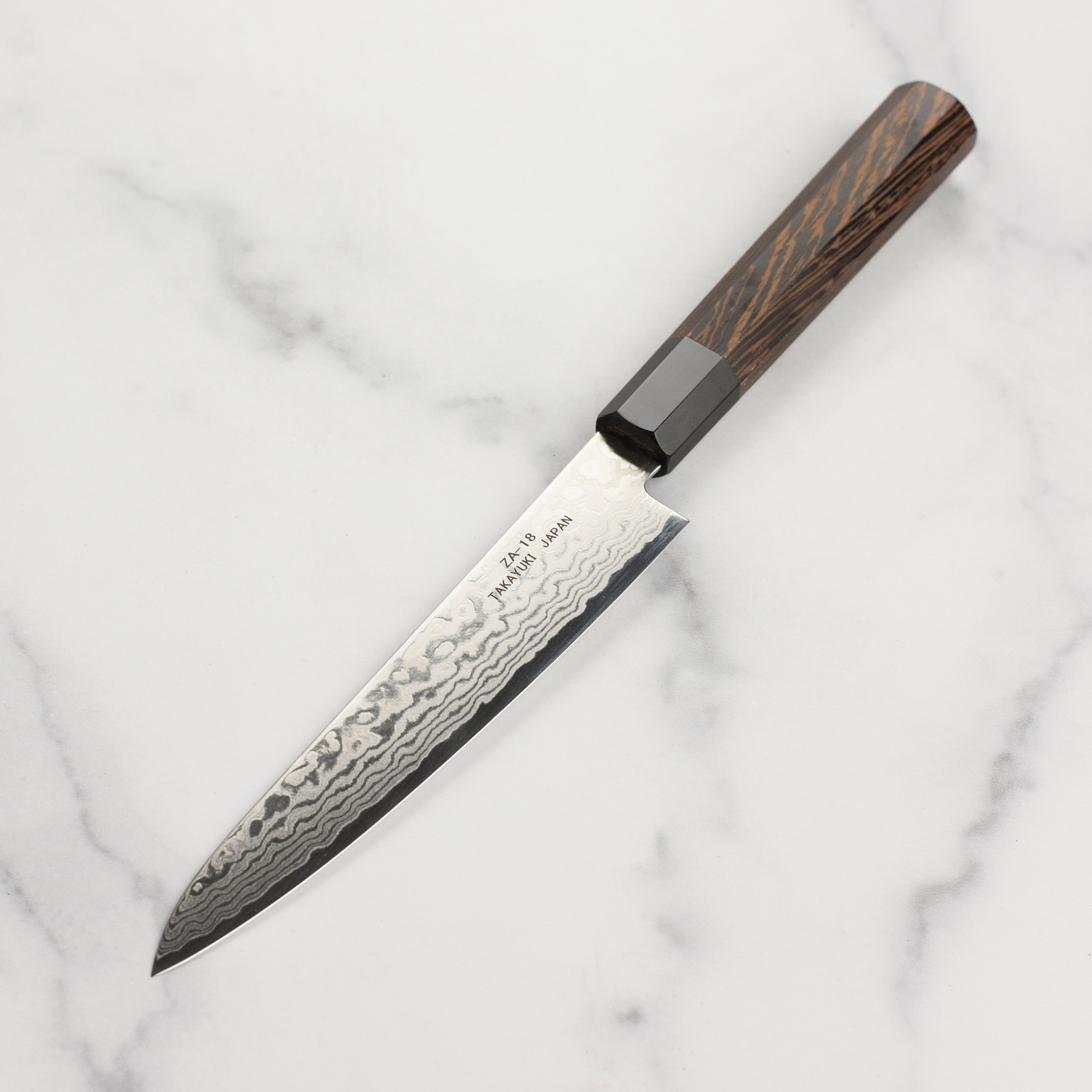 Takayuki Ginga ZA-18 petty knife in action, slicing fresh vegetables with precision.