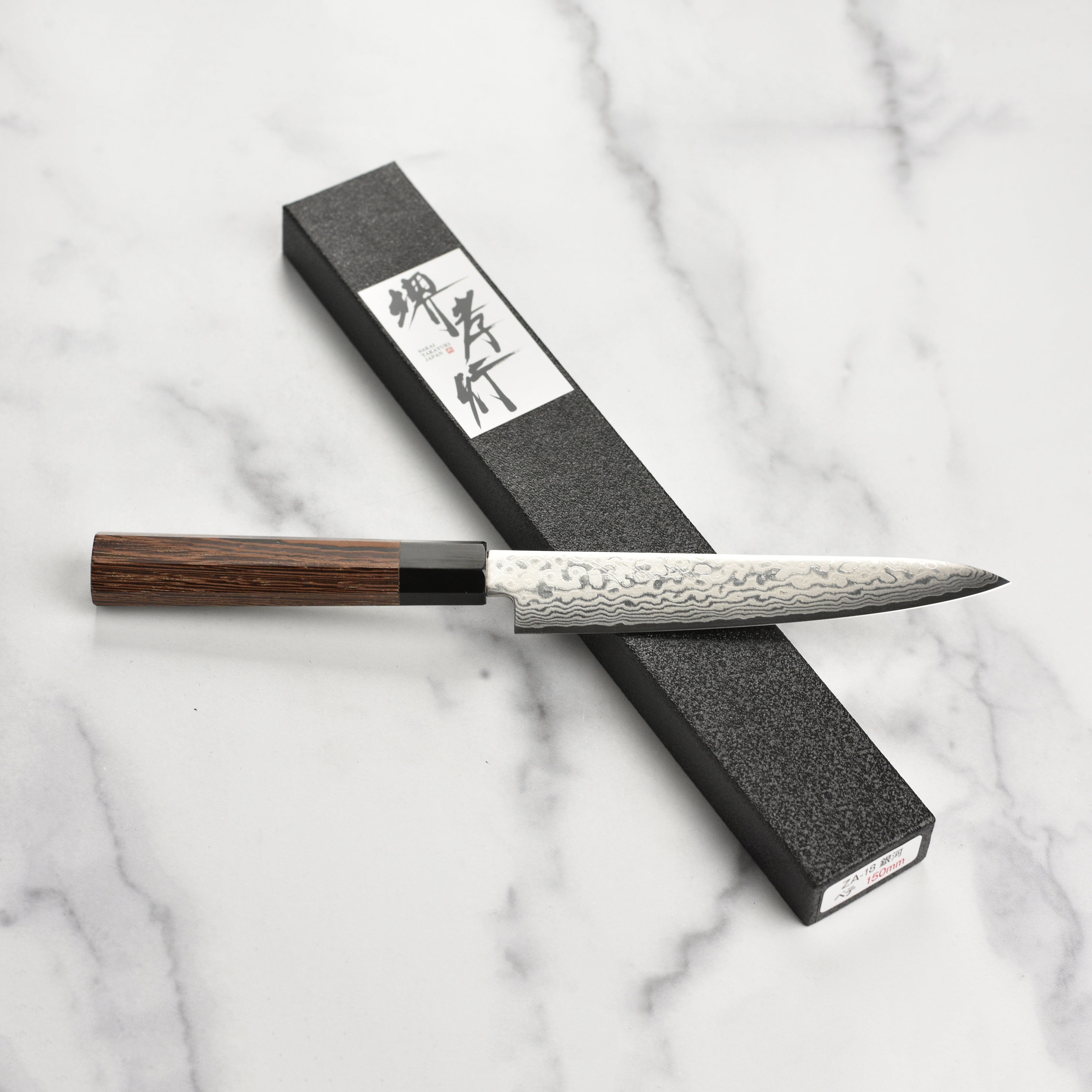 Detailed shot of the wenge wood handle and buffalo horn ferrule on the Takayuki Ginga ZA-18 petty knife.
