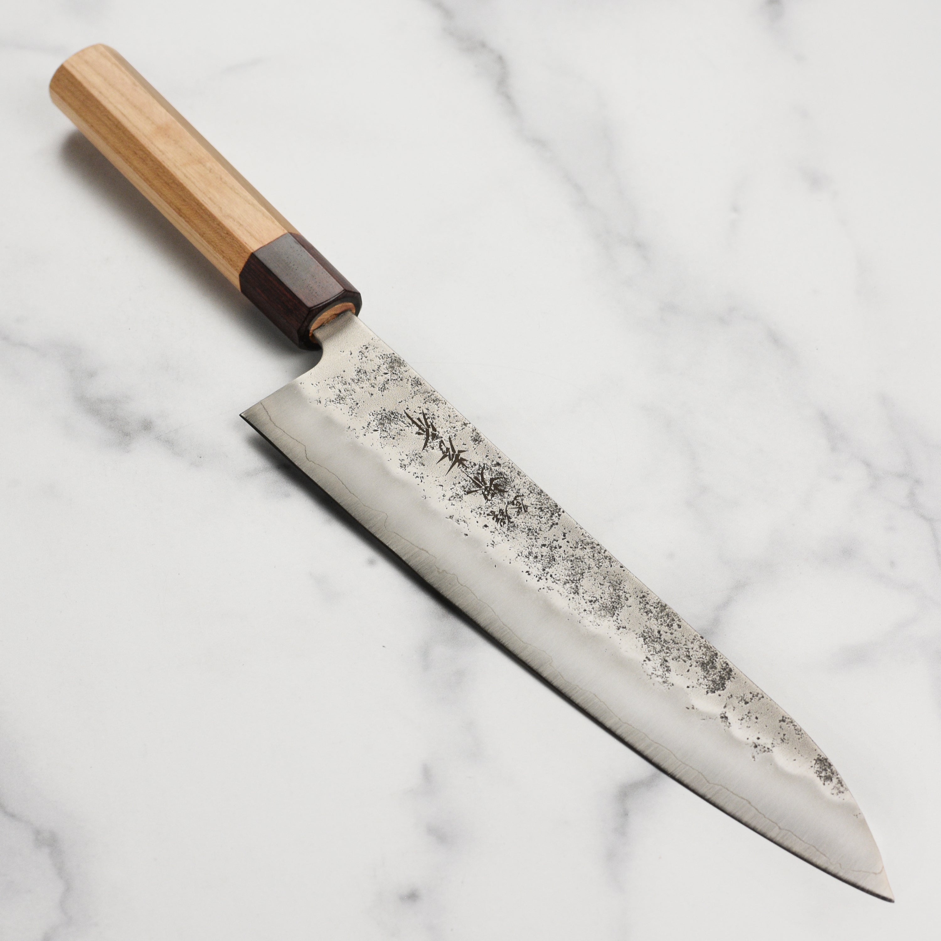 Close-up of the Sakai Ginsan Nashiji Gyuto Knife blade highlighting its nashiji finish.