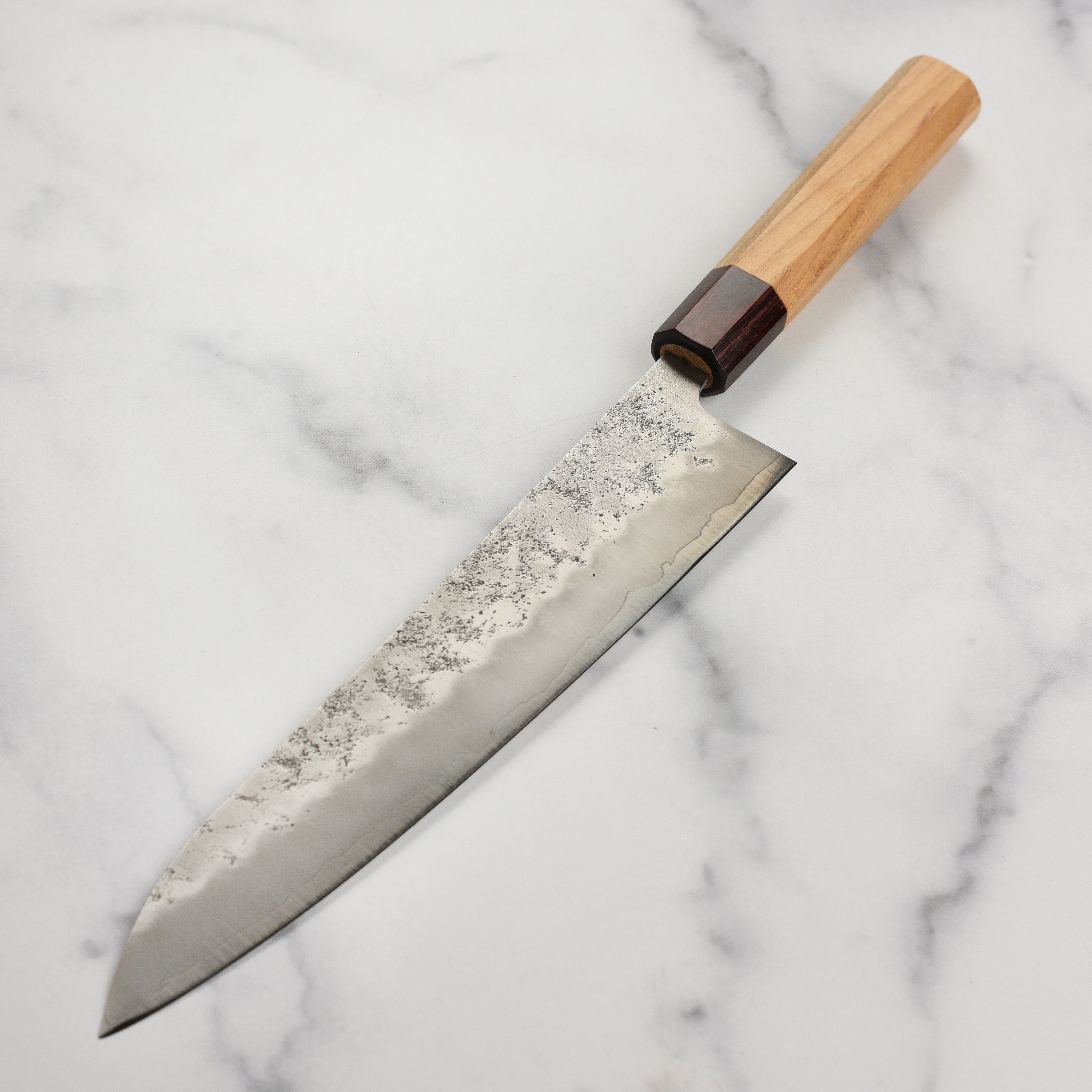Sakai Ginsan Nashiji Gyuto Knife in use, demonstrating its precision in slicing vegetables.