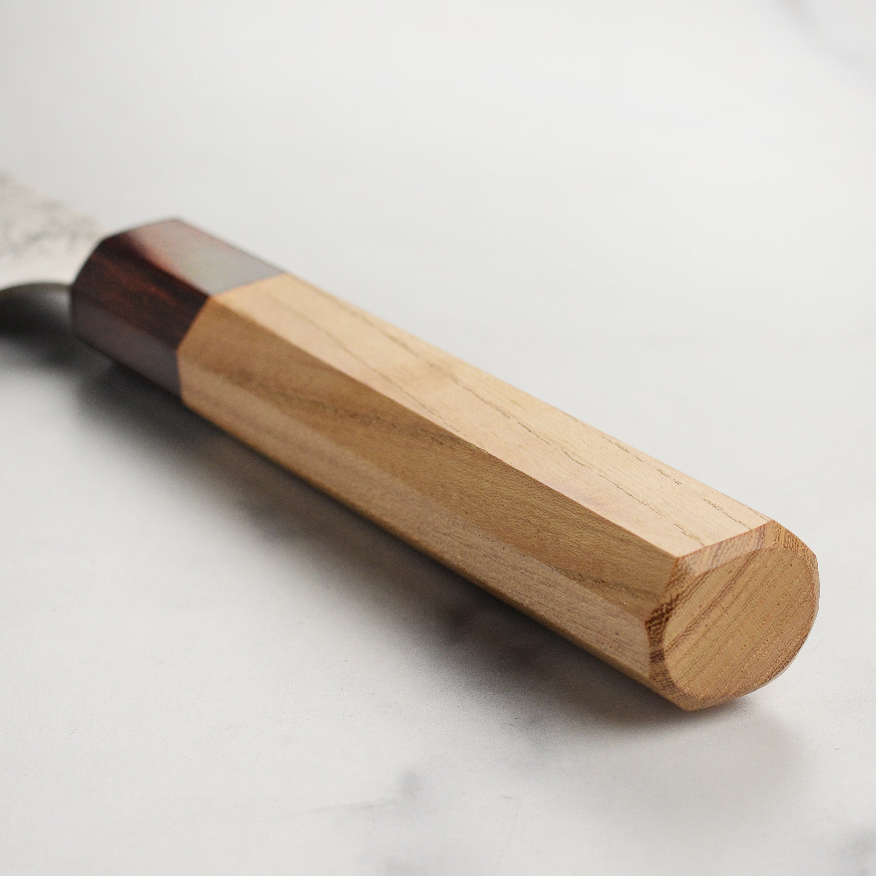 Sakai Ginsan Nashiji Gyuto Knife in use, demonstrating its precision in slicing vegetables.