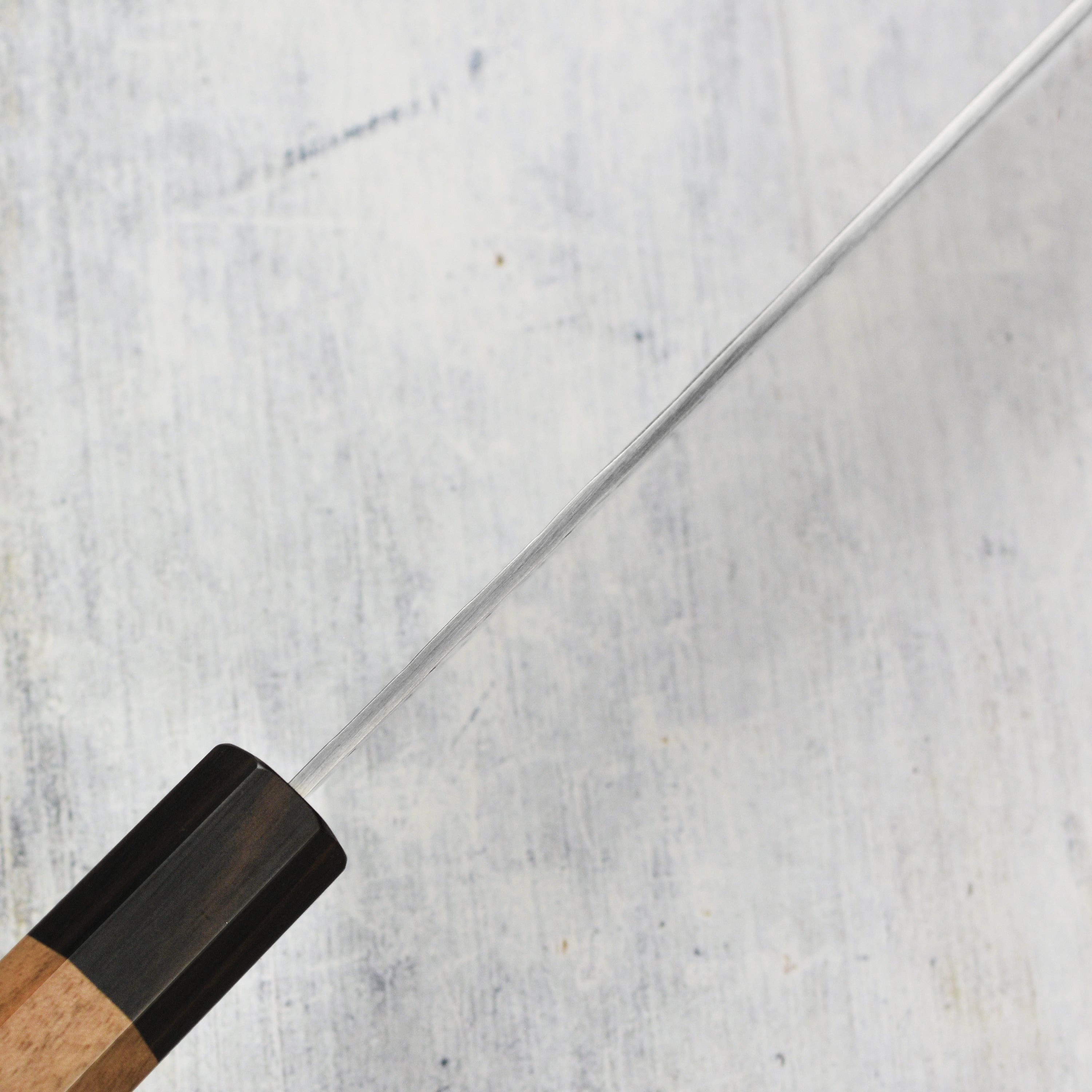 Chef slicing vegetables using the premium Japanese santoku knife from Takeshi Saji
