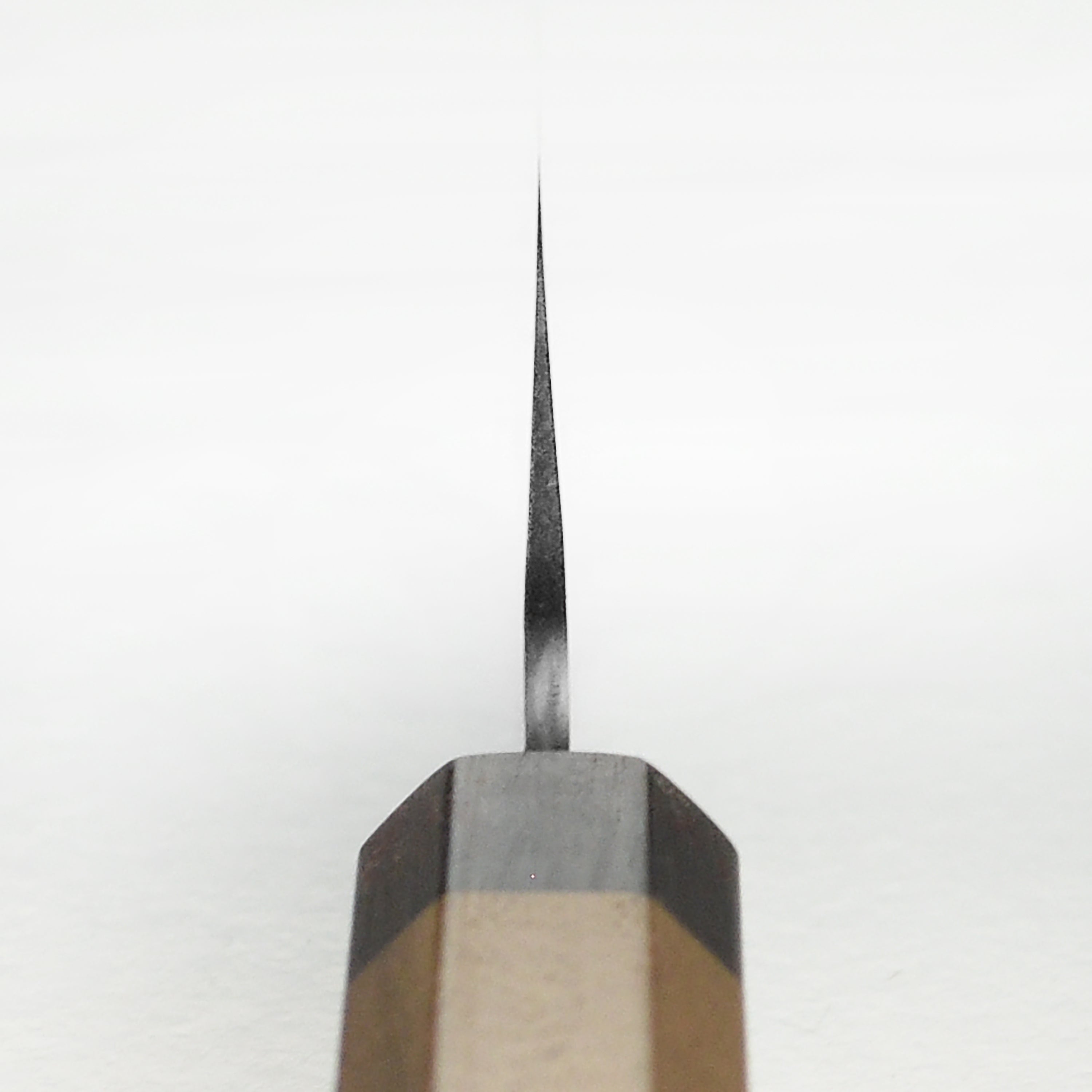 Side view of handmade Japanese kitchen knife highlighting walnut wood octagonal handle