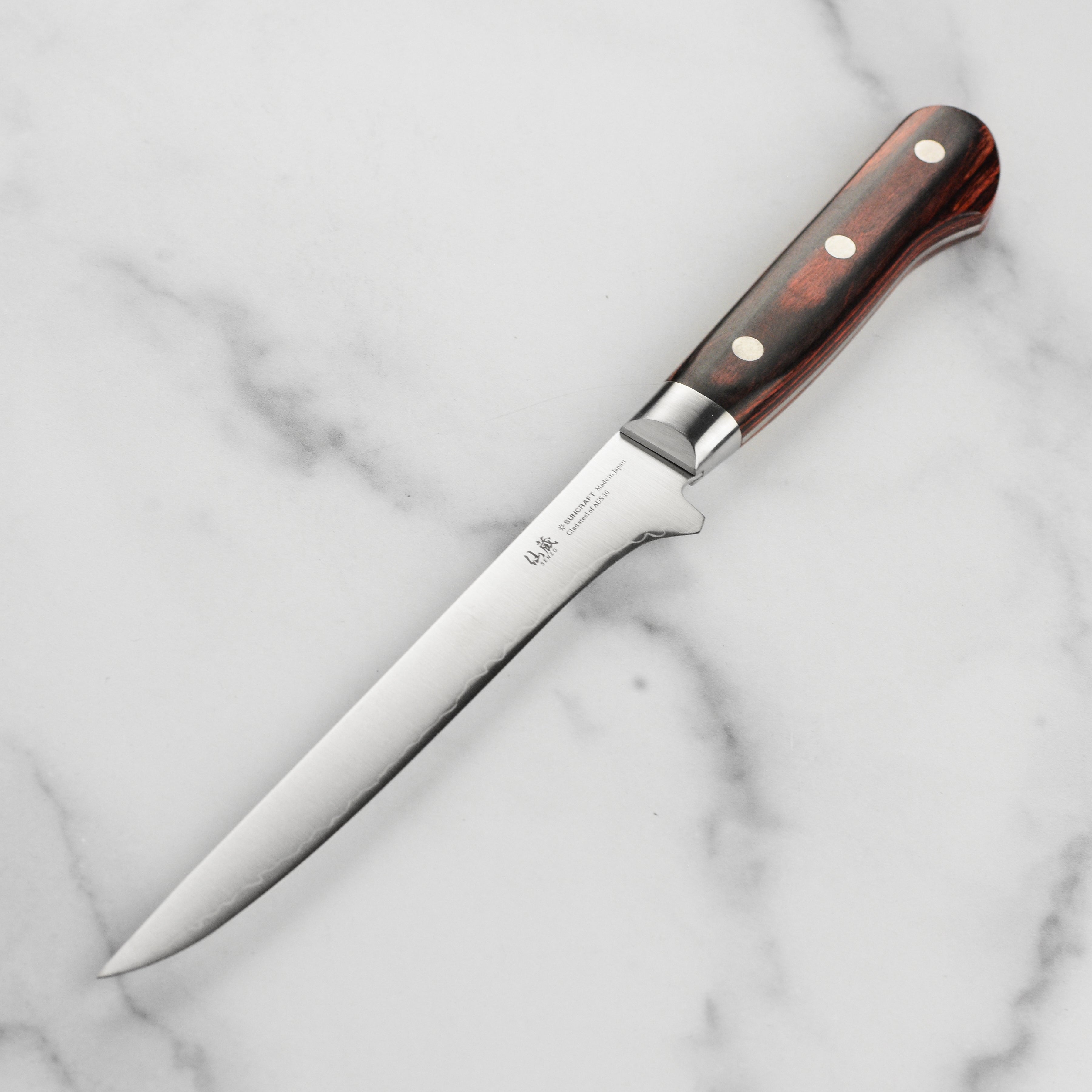 Japanese chef knife in use, highlighting high-quality stainless steel blade for home cooks