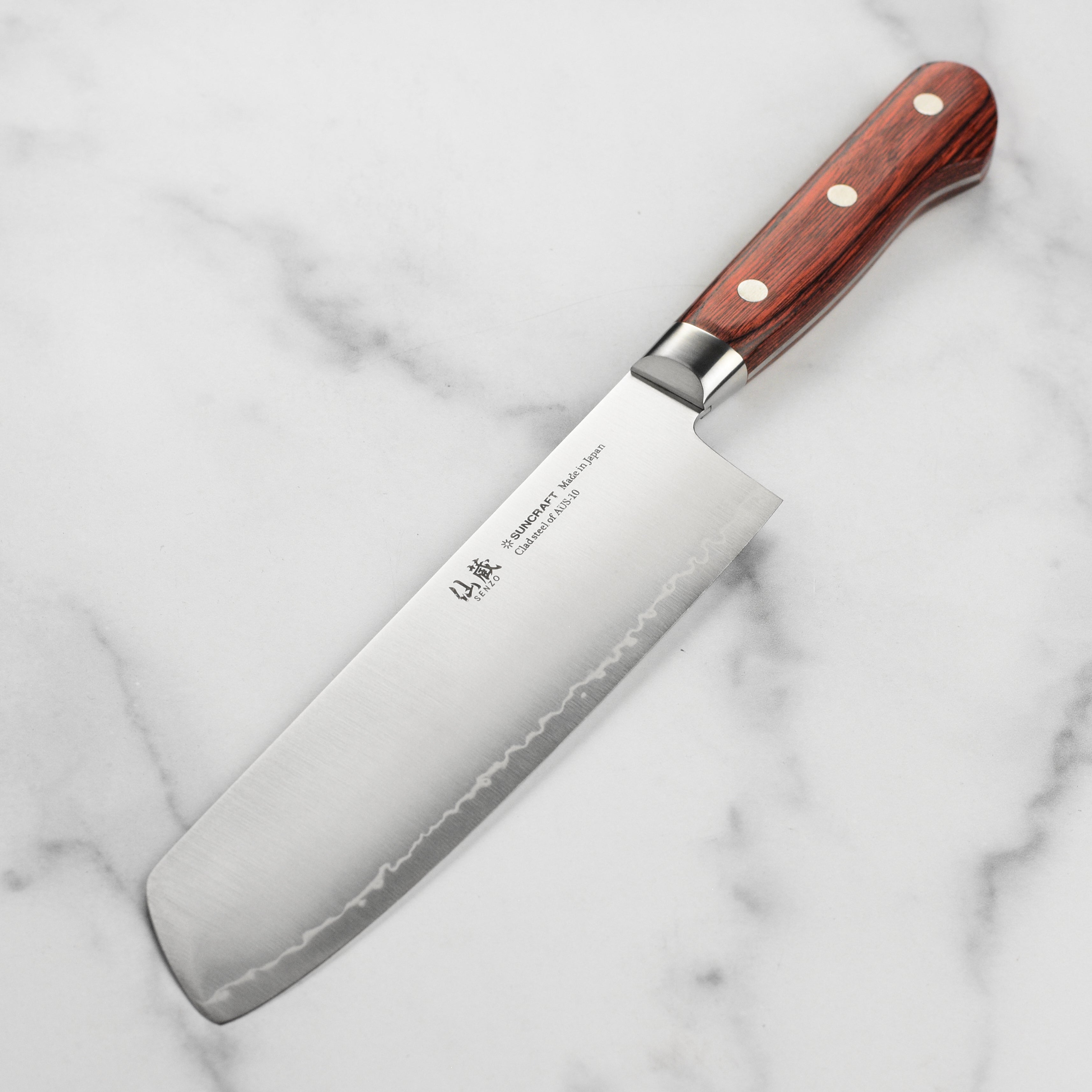A high-carbon AUS10 steel kitchen knife in a traditional Japanese style