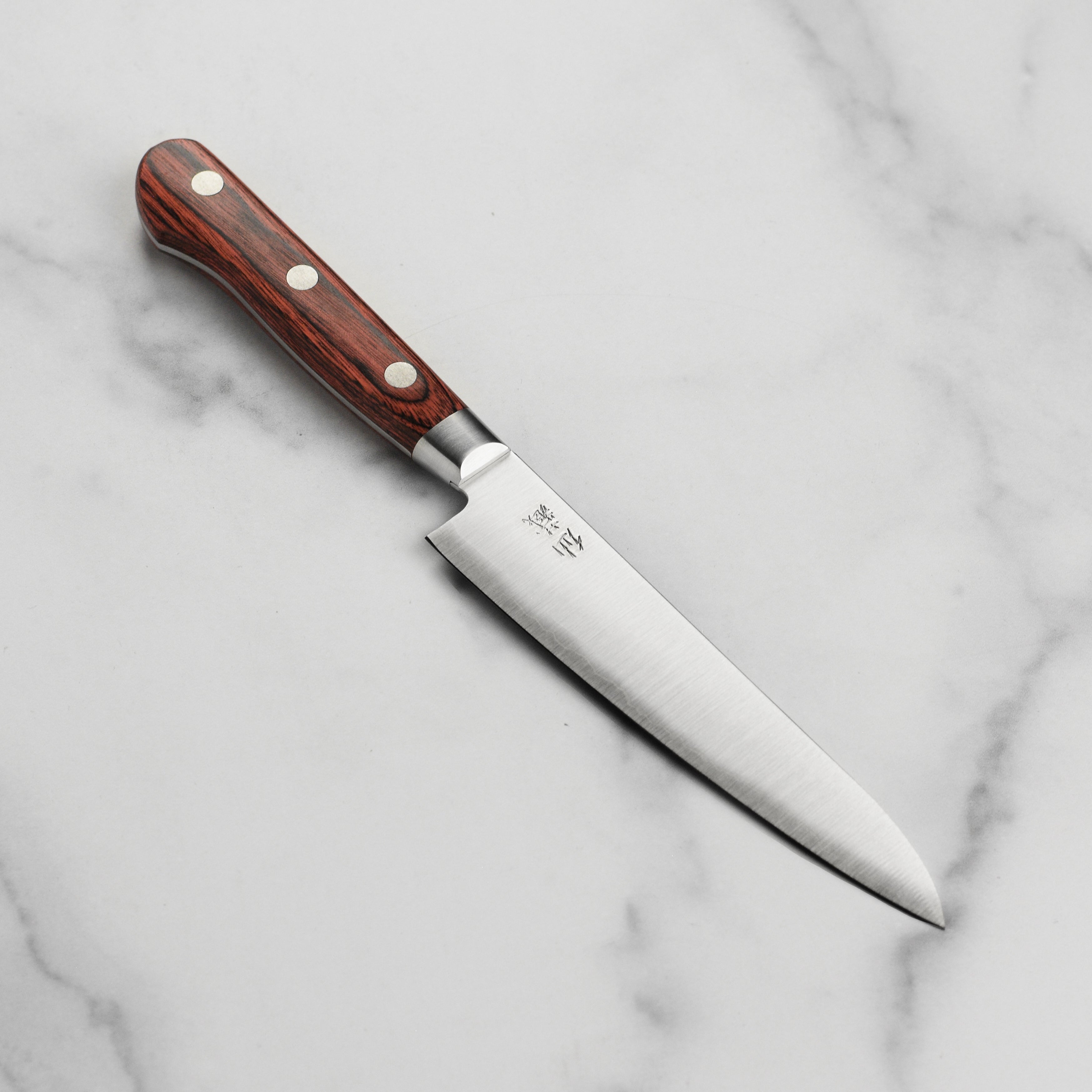 Senzo Clad AUS10 utility knife showcasing its sleek blade and Pakkawood handle.