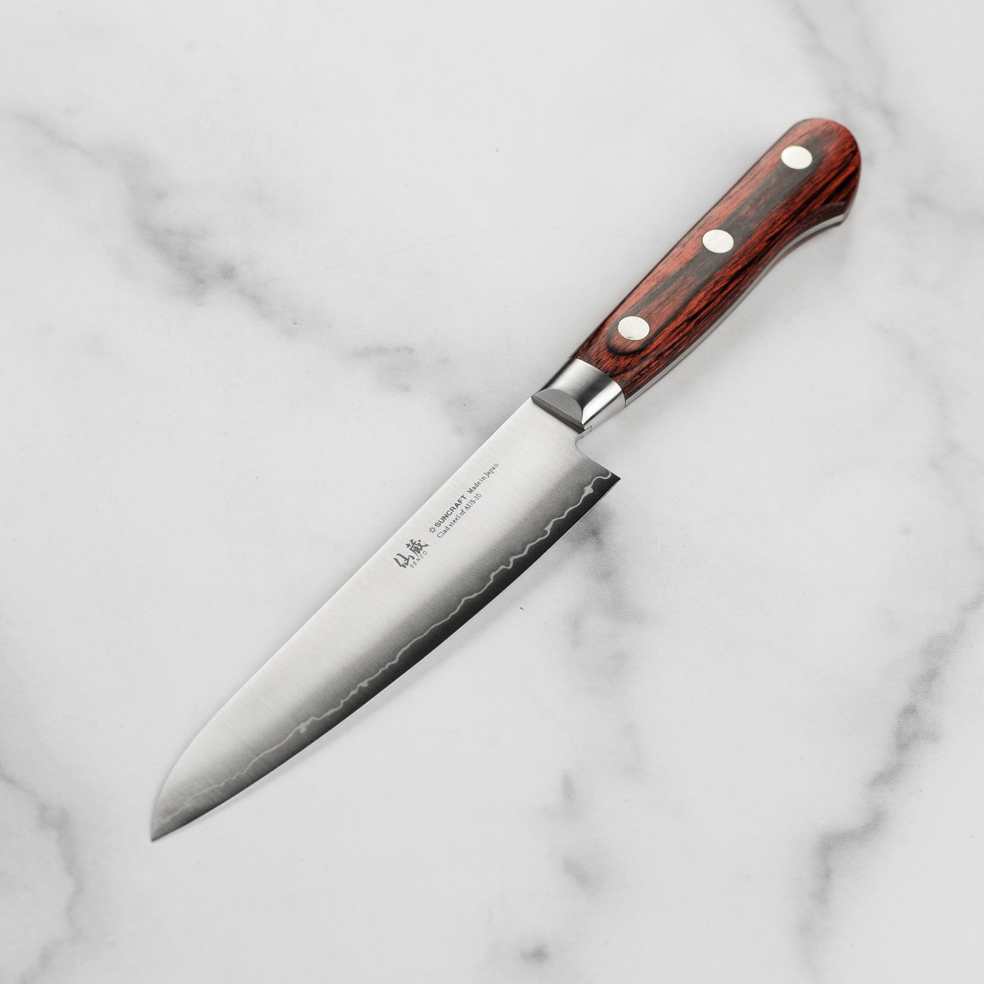 Close-up of the AUS10 stainless steel blade highlighting the intricate craftsmanship.