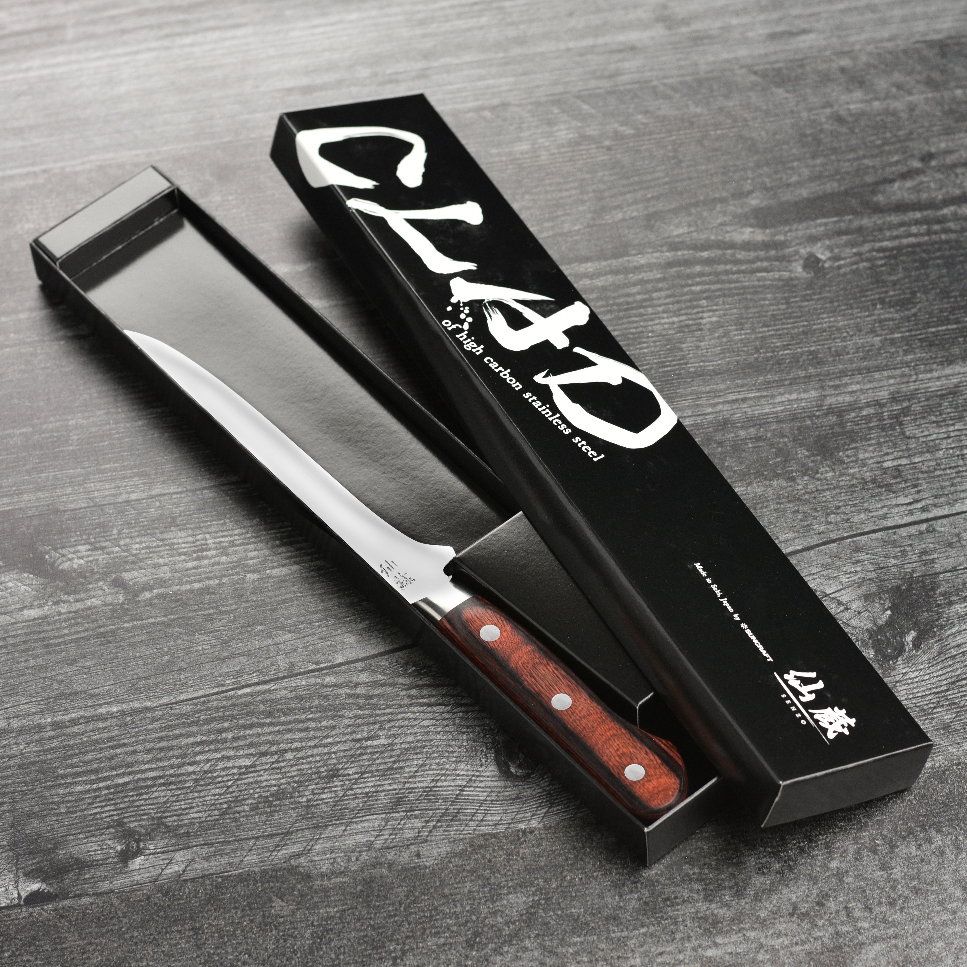 Close-up of the knifes bolster and riveted handle, showcasing craftsmanship