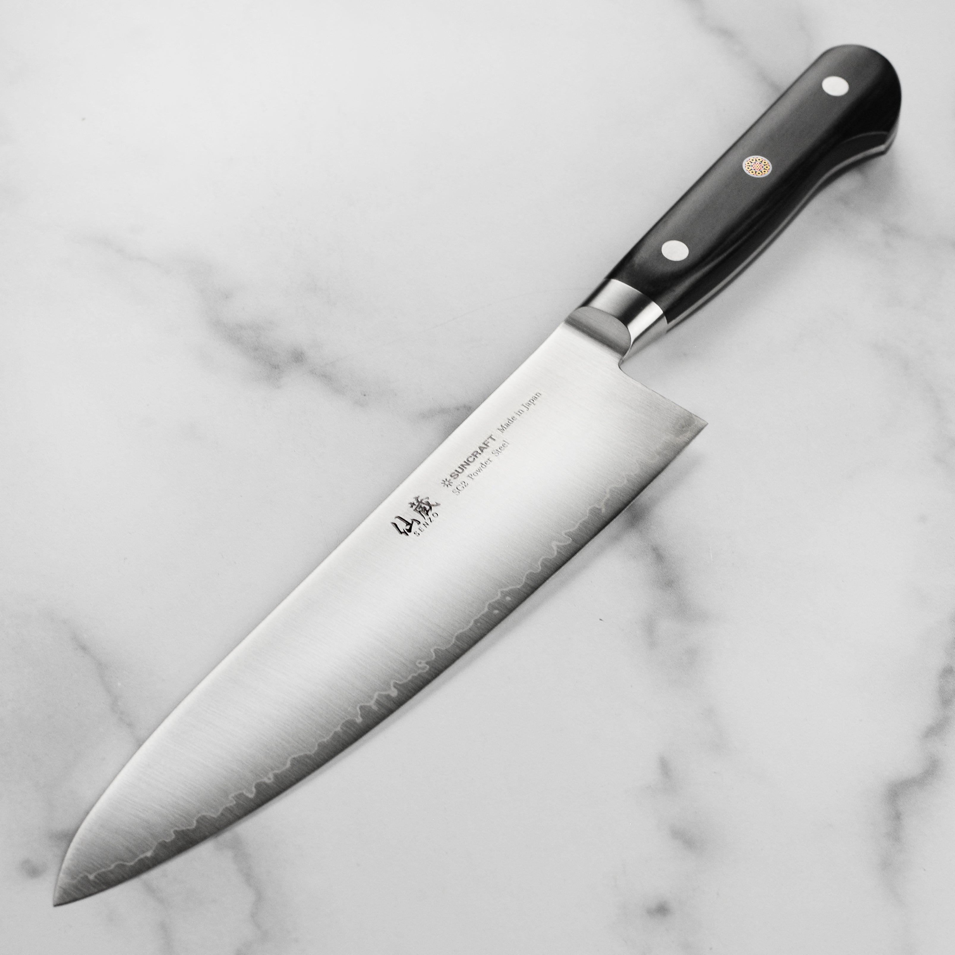 Close-up of the double bevel edge on the Suncraft Senzo Chefs Knife, highlighting its sharpness and precision.