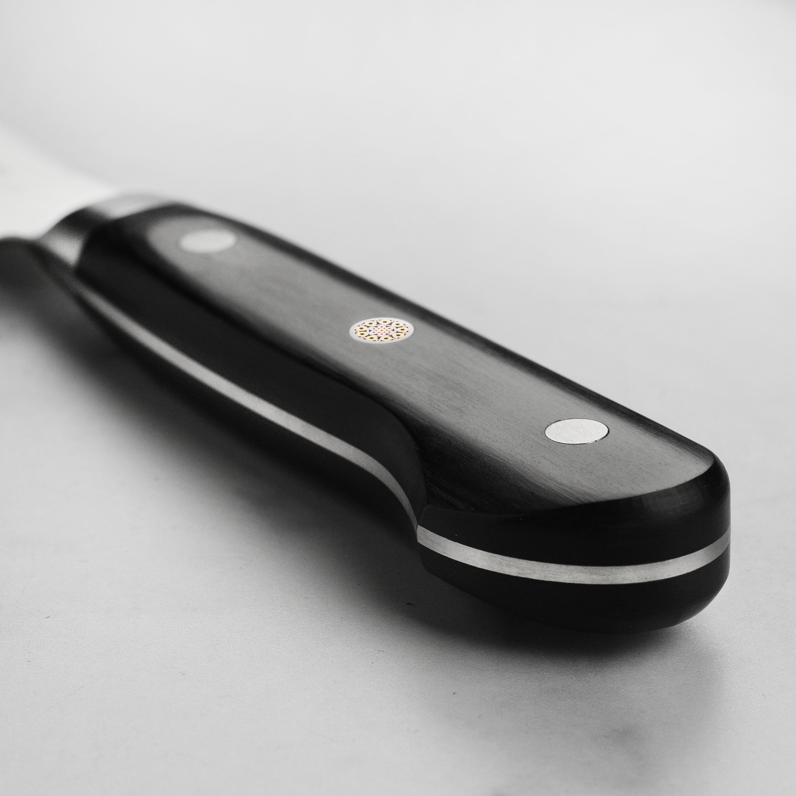 Chef using the Senzo Elite SG2 6.5-Inch Santoku Knife for precise vegetable slicing.