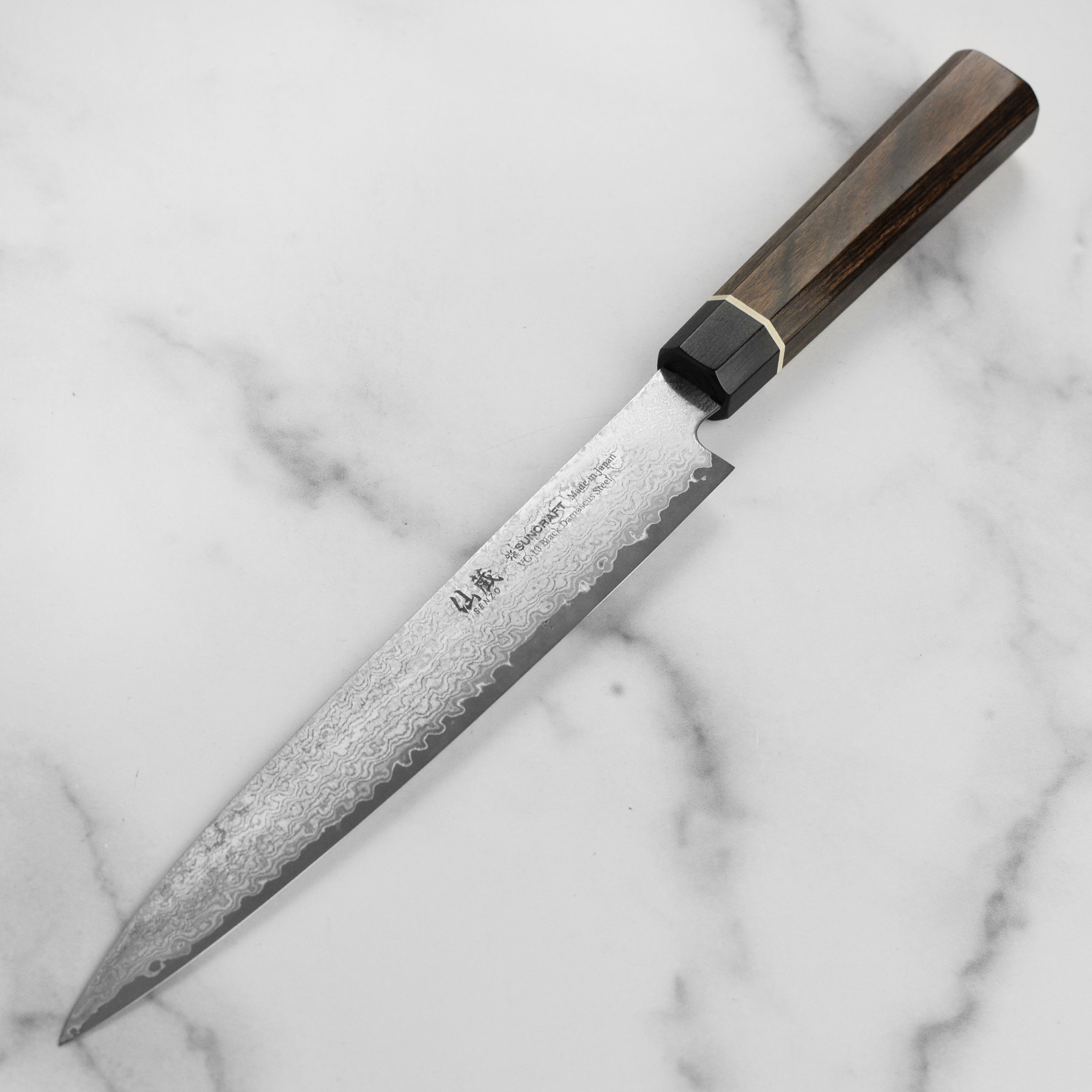 Chef slicing meat with the Senzo Black Damascus kitchen knife