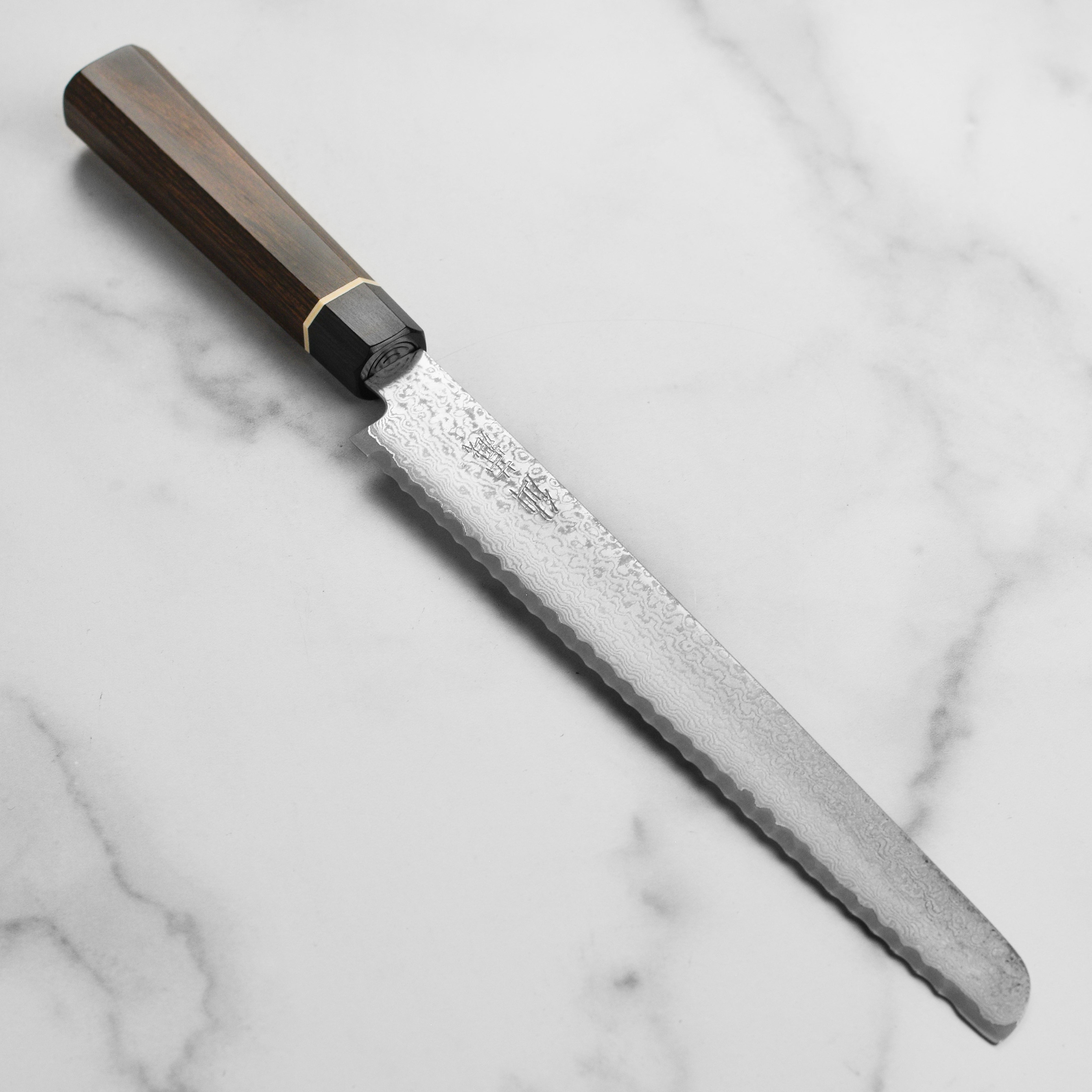 Senzo Black Damascus 8.5-inch bread knife with layered steel pattern and Pakkawood handle, ideal for home use