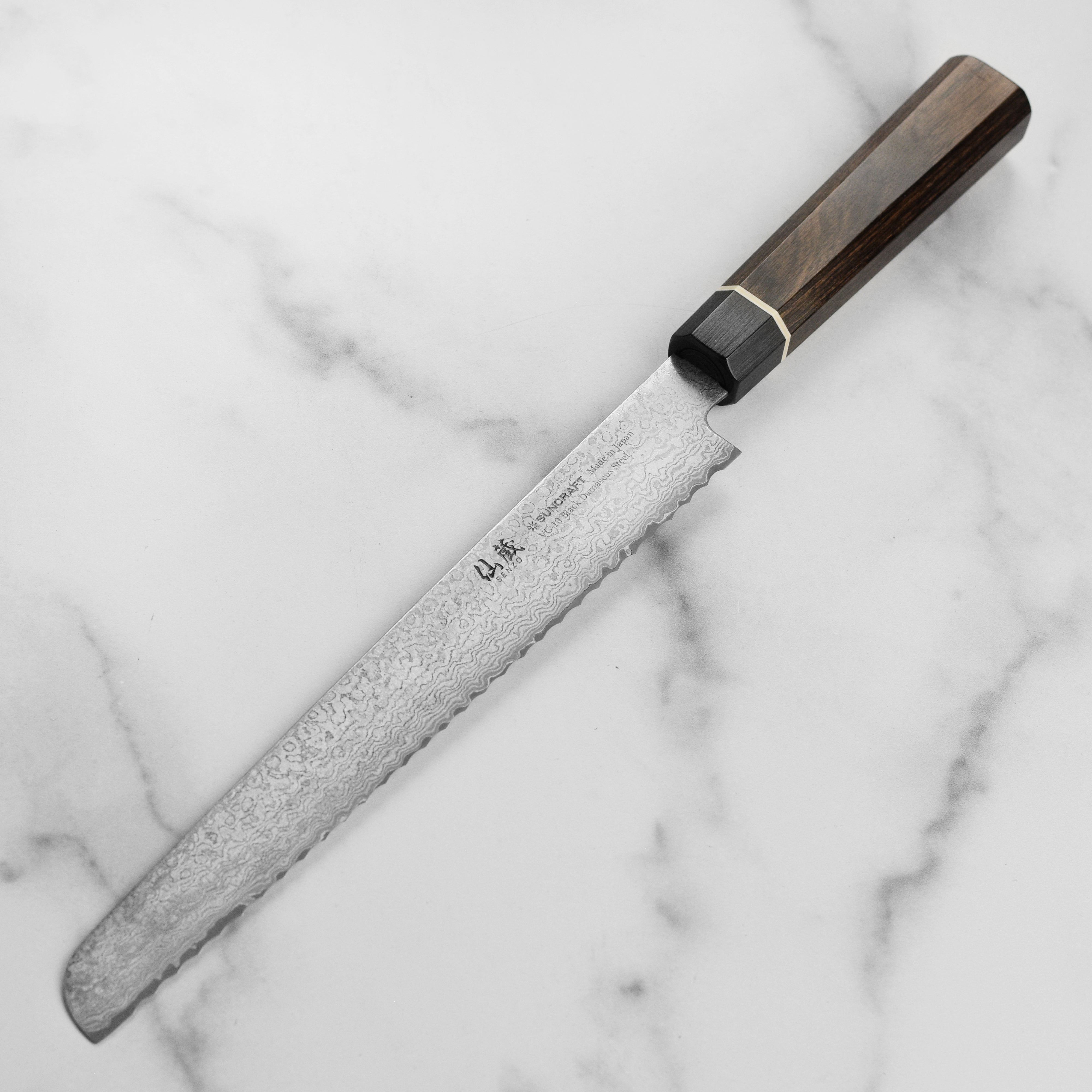 Close-up of the sharp edge of the Damascus bread knife, showcasing craftsmanship and quality