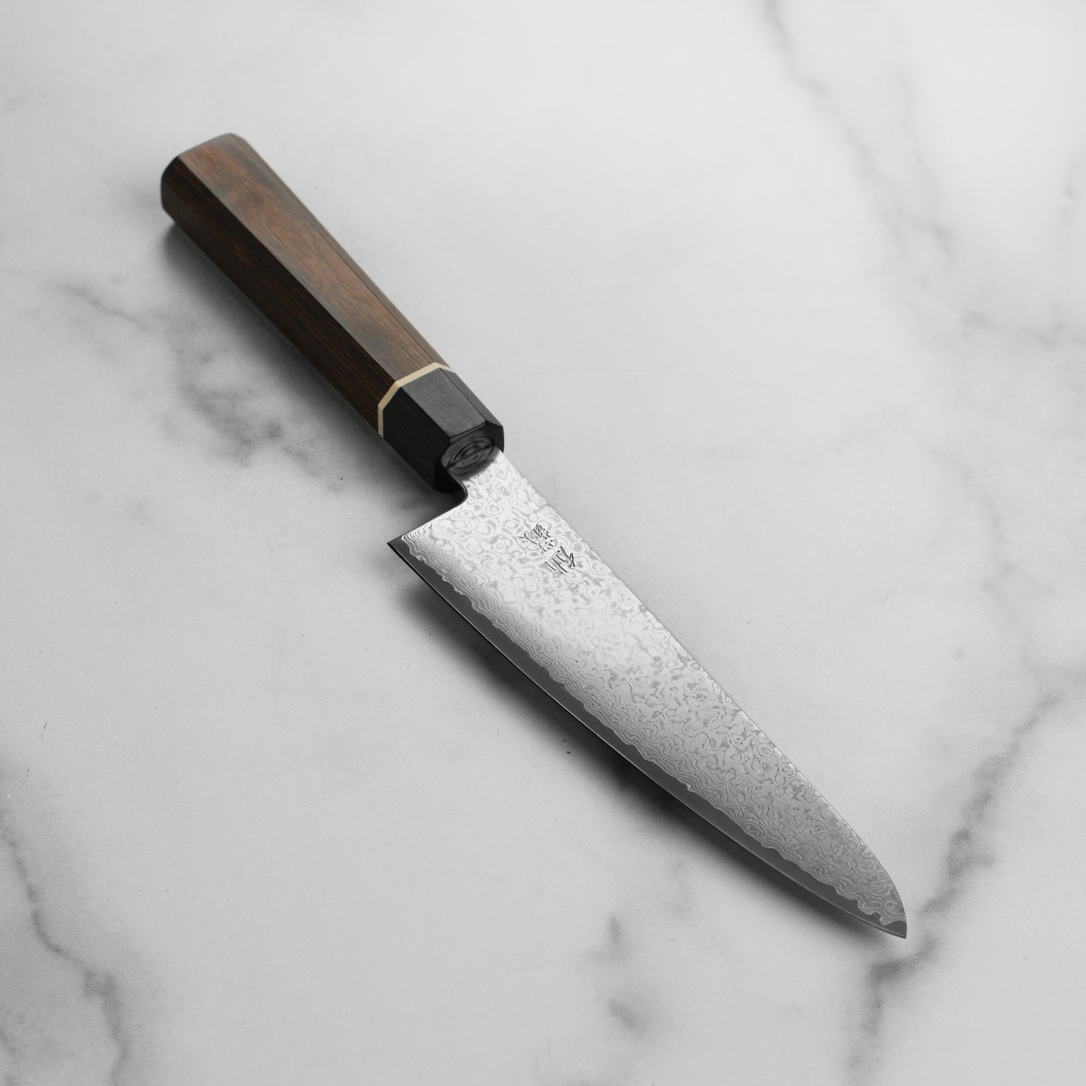 Senzu Black Damascus prep knife showing detailed layered blade with dark Damascus pattern