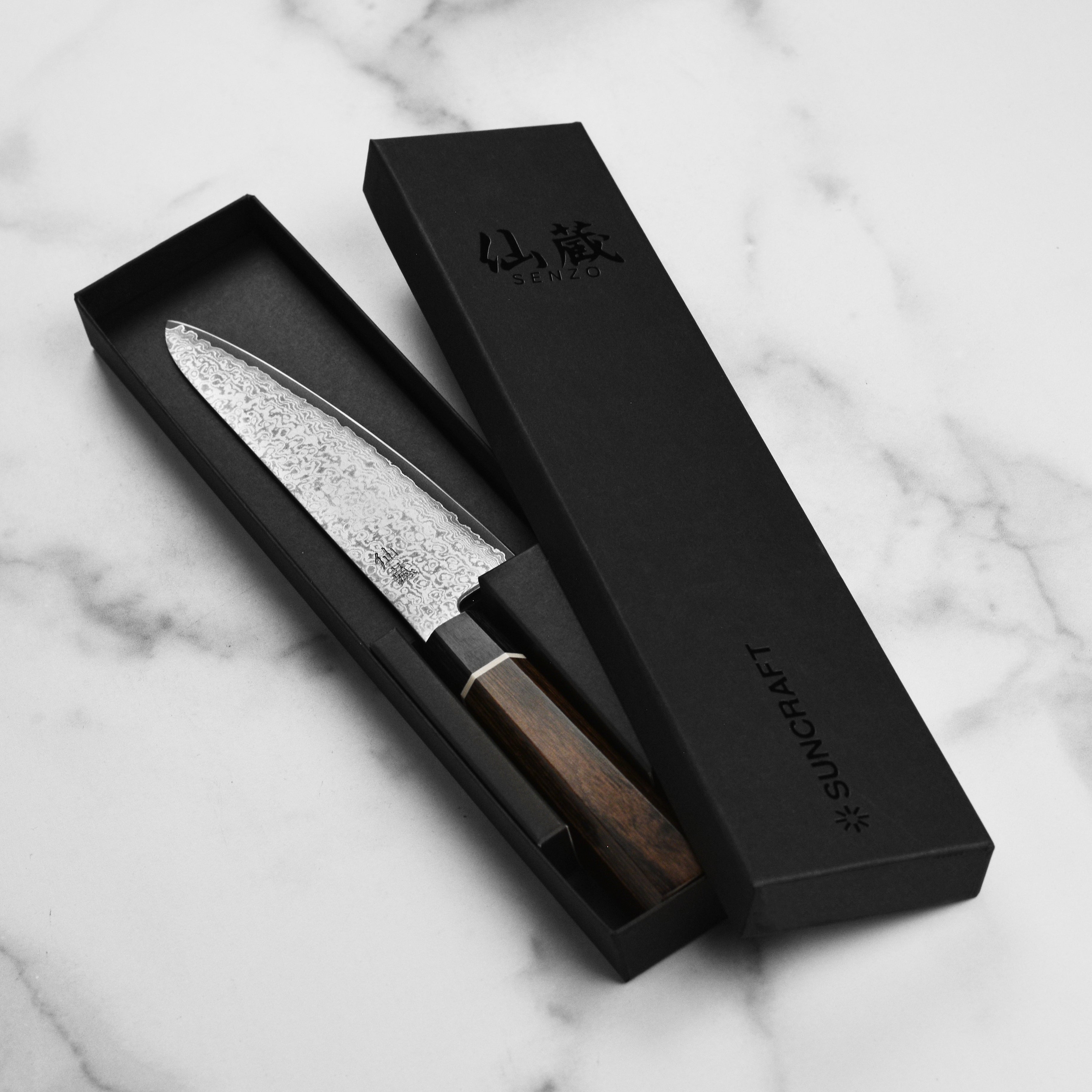 Close-up of the Pakkawood octagon handle on the Senzu Black Damascus prep knife